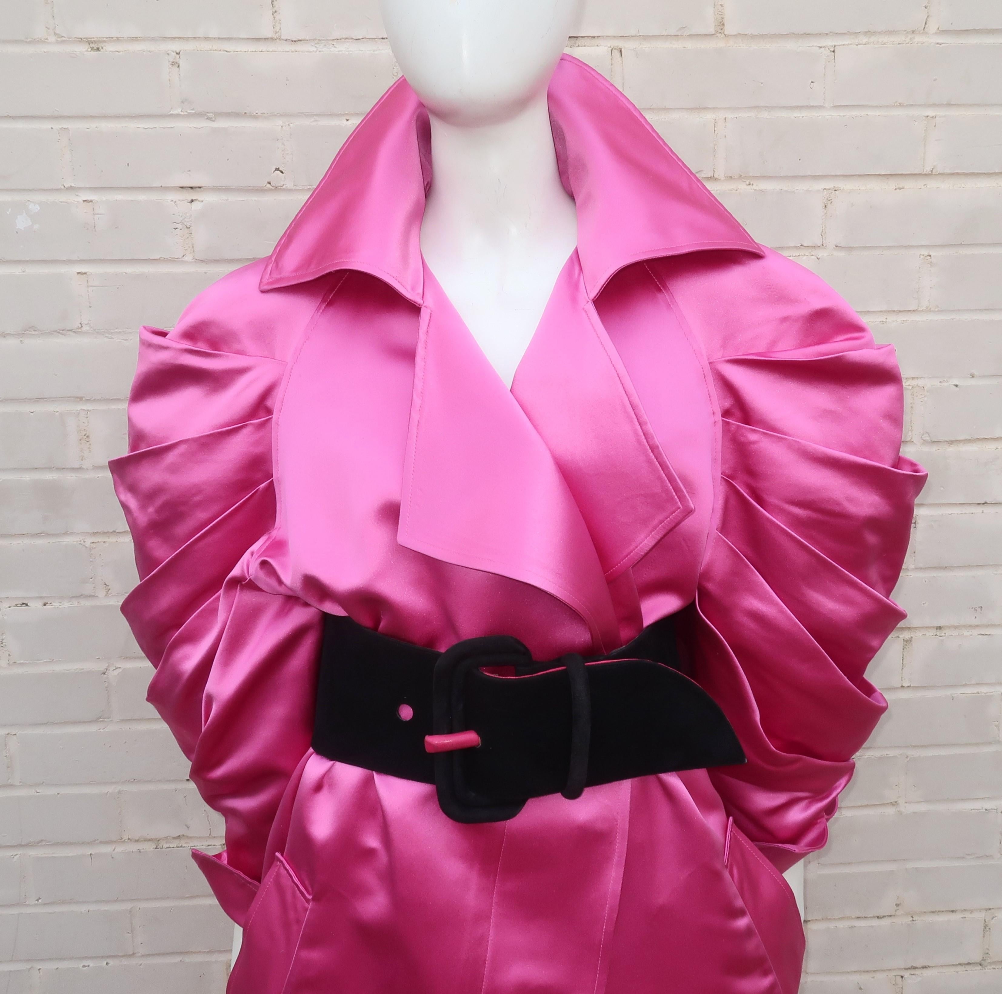Claude Montana’s strong silhouettes epitomizes 1980’s style with sculptural shapes and high quality construction.  This hot pink silk satin coat is a wonderful example of his work.  The coat buttons at the front with a hidden panel and sports ruched