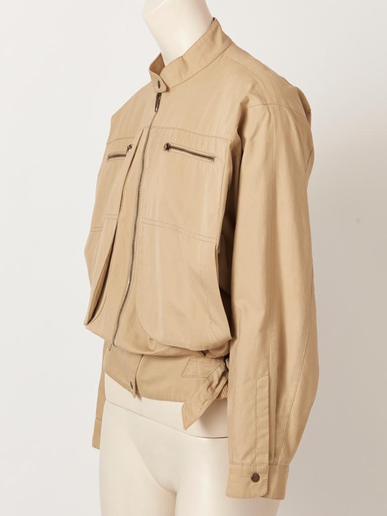 Claude Montana, Dolman sleeve, khaki tone, cotton, 80's bomber style jacket, having a tab collar, exaggerated patch pockets at the bust with zipper detail. Metal zipper closure and knitted detail at the waist with adjustable 