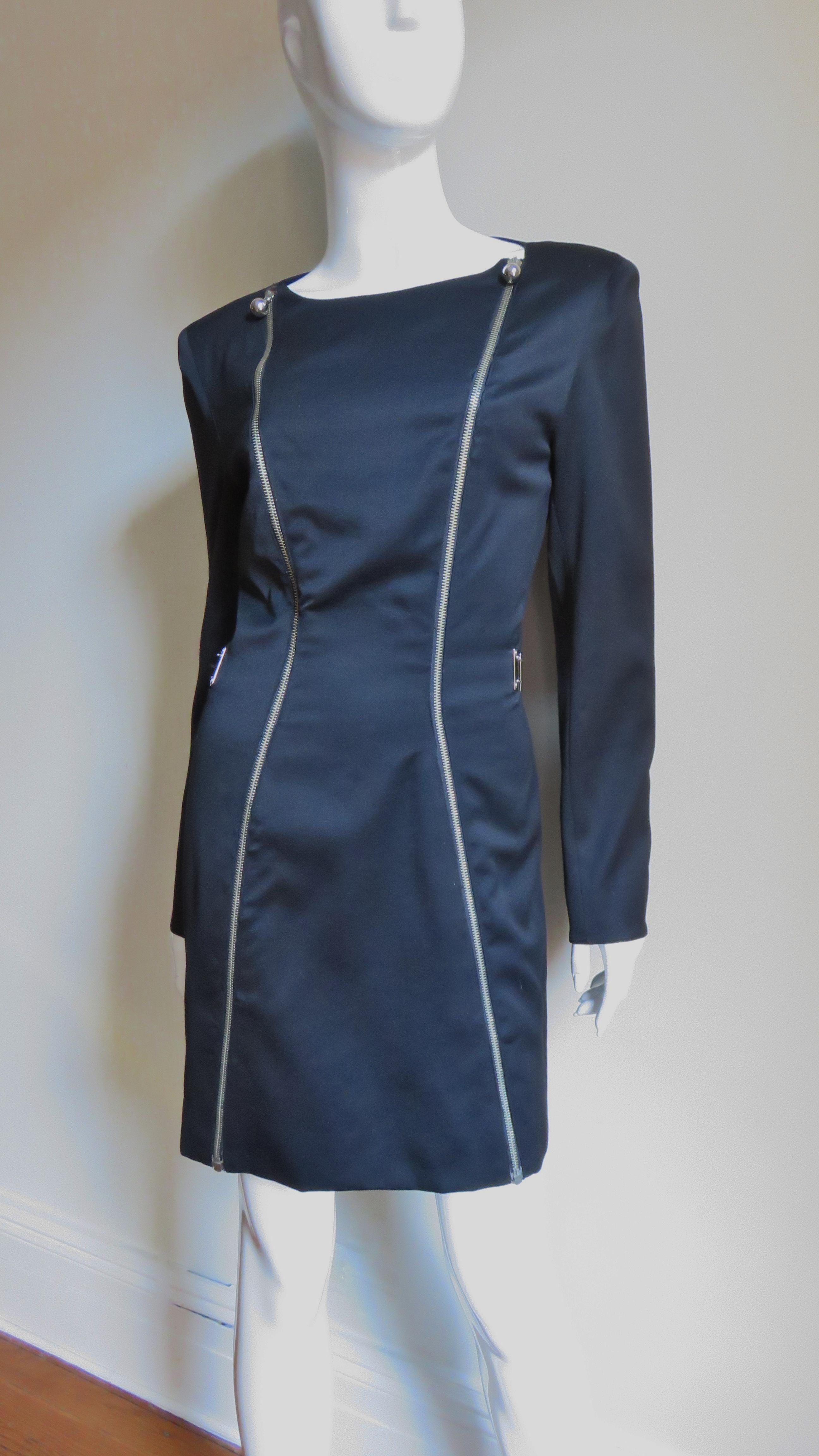 A fabulous black silk wool blend dress from Claude Montana.  It has a space age node with it's double zipper front and cuffs all with silver ball pulls plus a silver rectangular linked articulated half belt in the back.  It has small shoulder pads