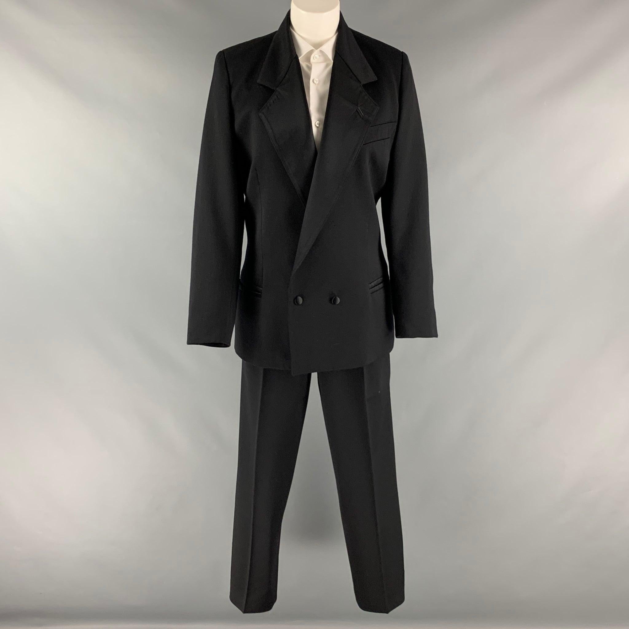 CLAUDE MONTANA pants suit set comes in a black silk woven material and includes a shoulder pads, notch lapel, double breasted jacket, and matching high waist pleated front pants.Very Good Pre- Owned Conditions. Moderate marks of wear. 

Marked:   46