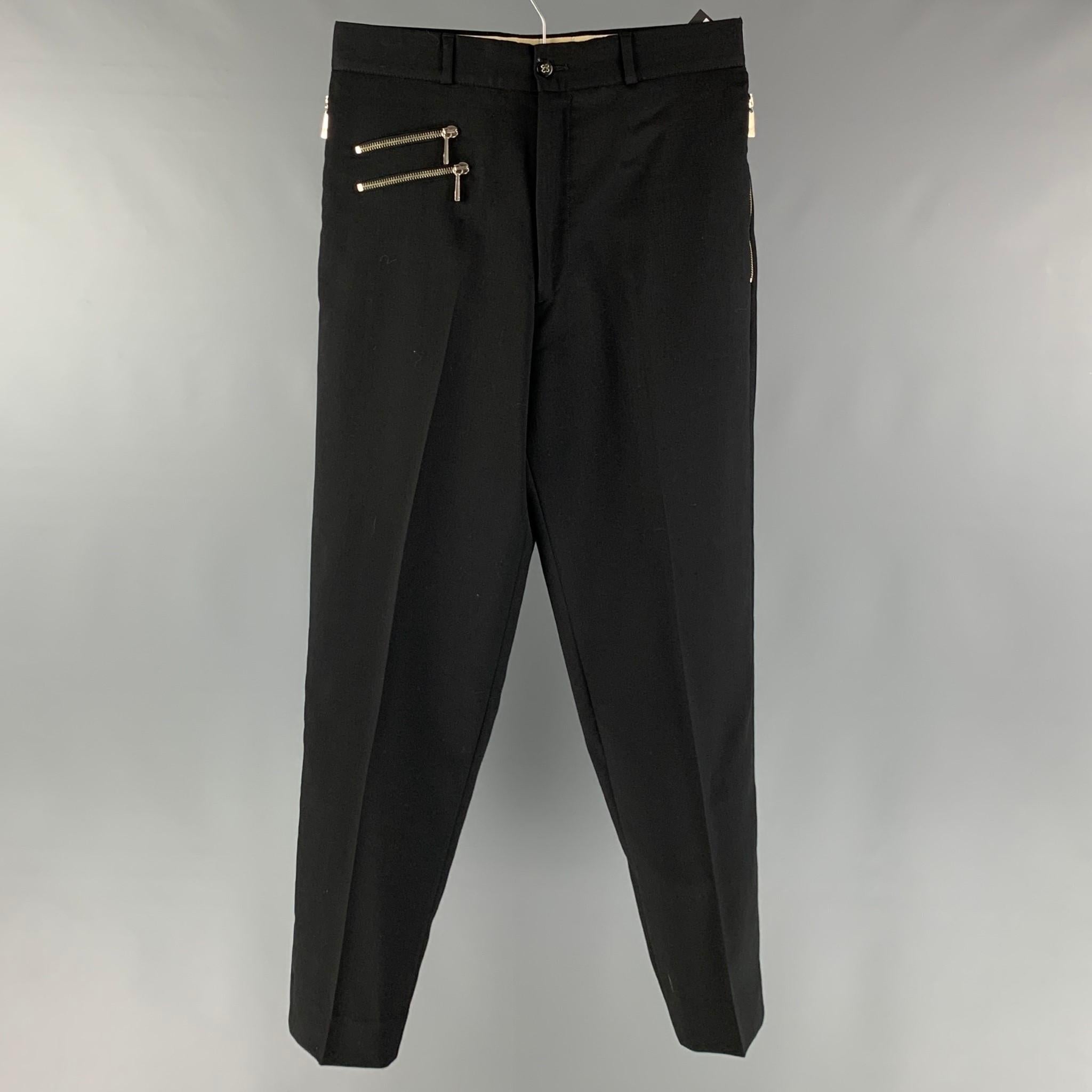VINTAGE CLAUDE MONTANA dress pants comes in a black wool woven material featuring a flat front, zipper details, zipper pockets, and a zipper fly closure.

Very Good Pre-Owned Condition.
Marked: 48

Measurements:

Waist: 31 in.
Rise: 10.5 in.
Inseam: