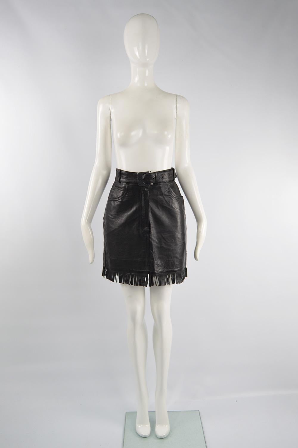 A fabulous vintage Claude Montana mini skirt from the early 90s. In a black genuine leather with fringes along the bottom and a matching western style belt. Perfect for a party. 

Size: Marked vintage 40 but fits more like a modern UK 8-10/ US 4-6/