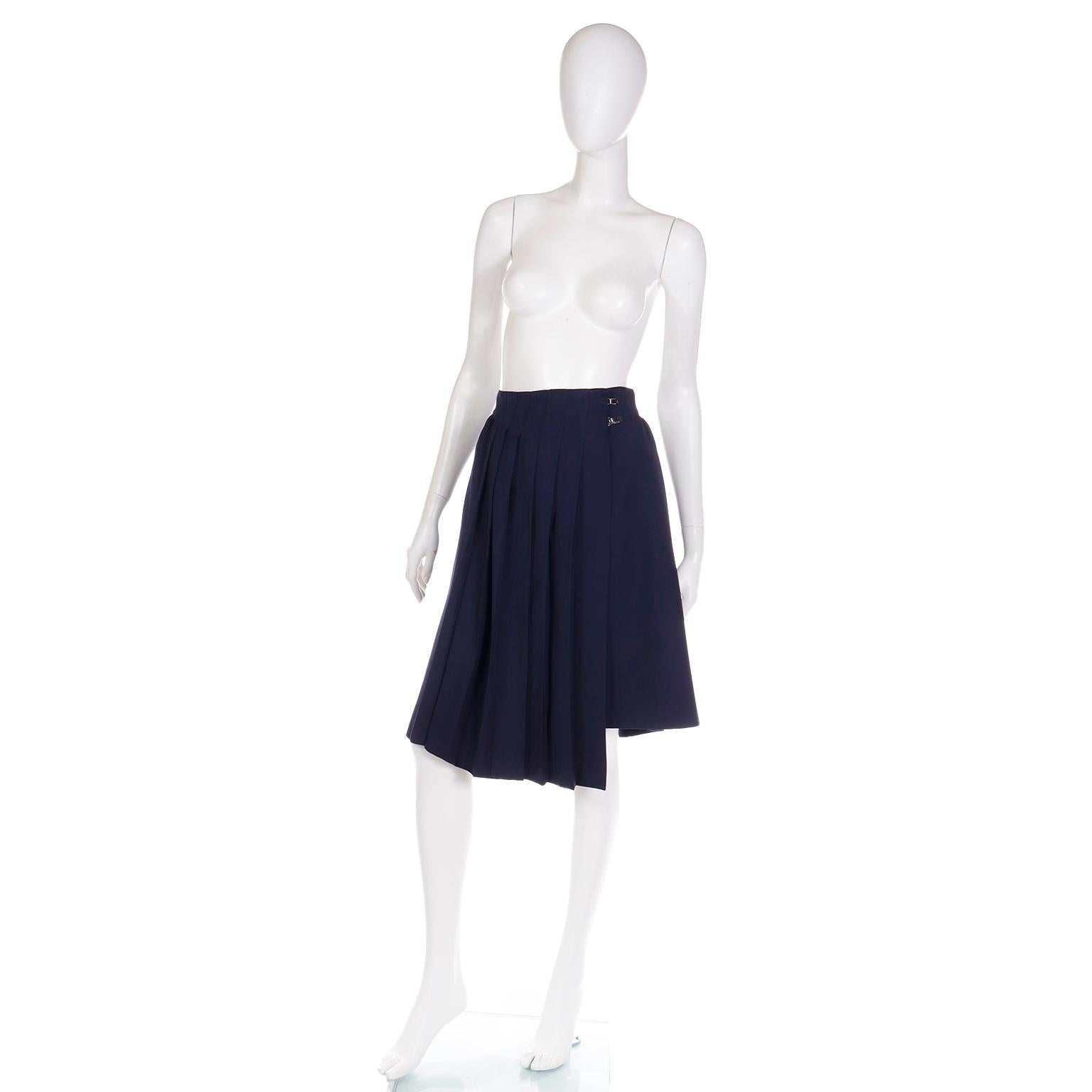 This 1980's Claude Montana avant garde, dramatically pleated navy blue skirt is so unique and stylish. The skirt wraps in front, securing with two metal toggles that are signature Montana elements. The skirt has 2 side slit pockets, beautiful pleats