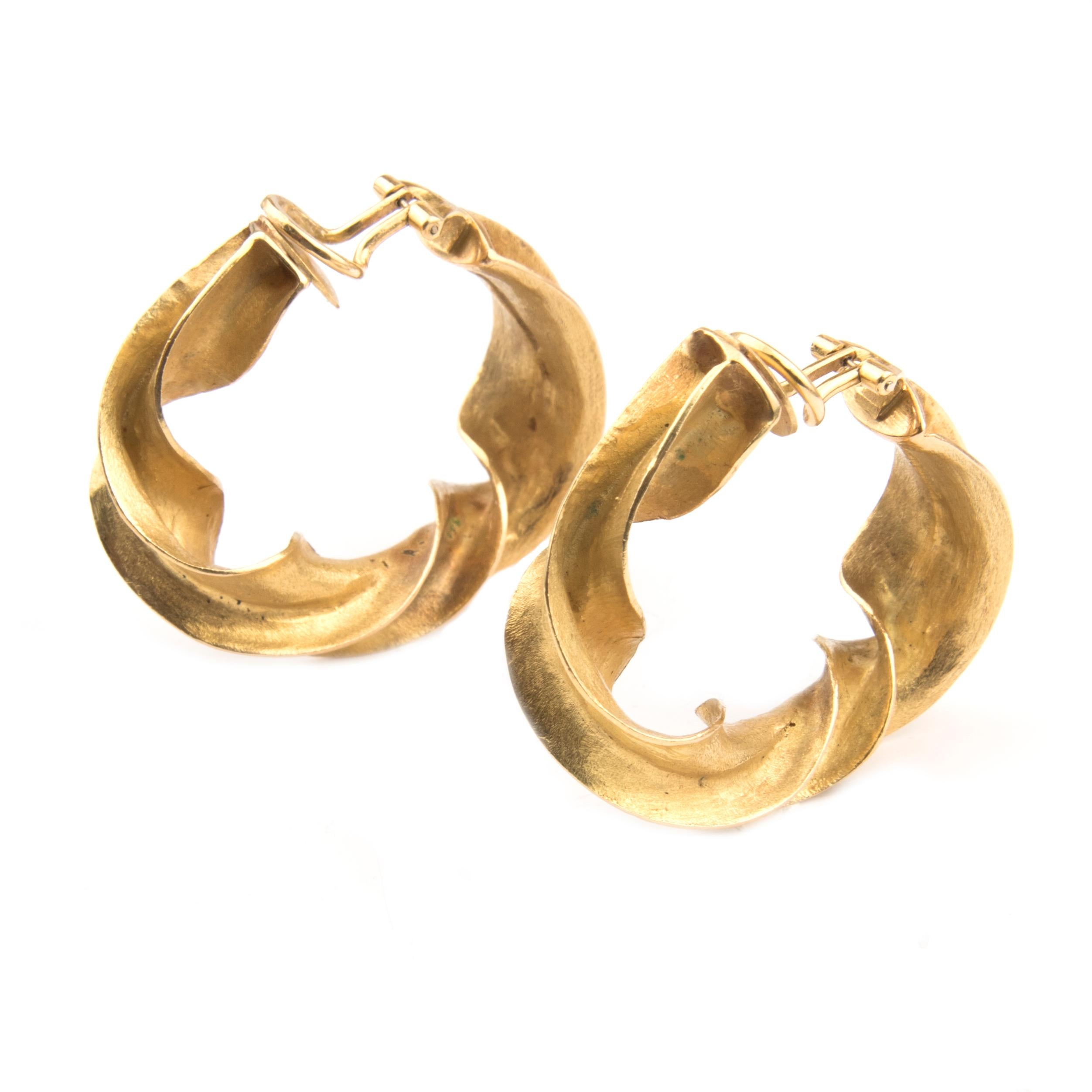Pair of hand made clip-on earrings by Claude Pelletier, matt 18k yellow gold, designed as irregular twisted hoops
Stamped S.F.H, maker's mark CP for Claude Pelletier, French hallmarks
Ca. 1970

Claude Pelletier (1930) is a French goldsmith and