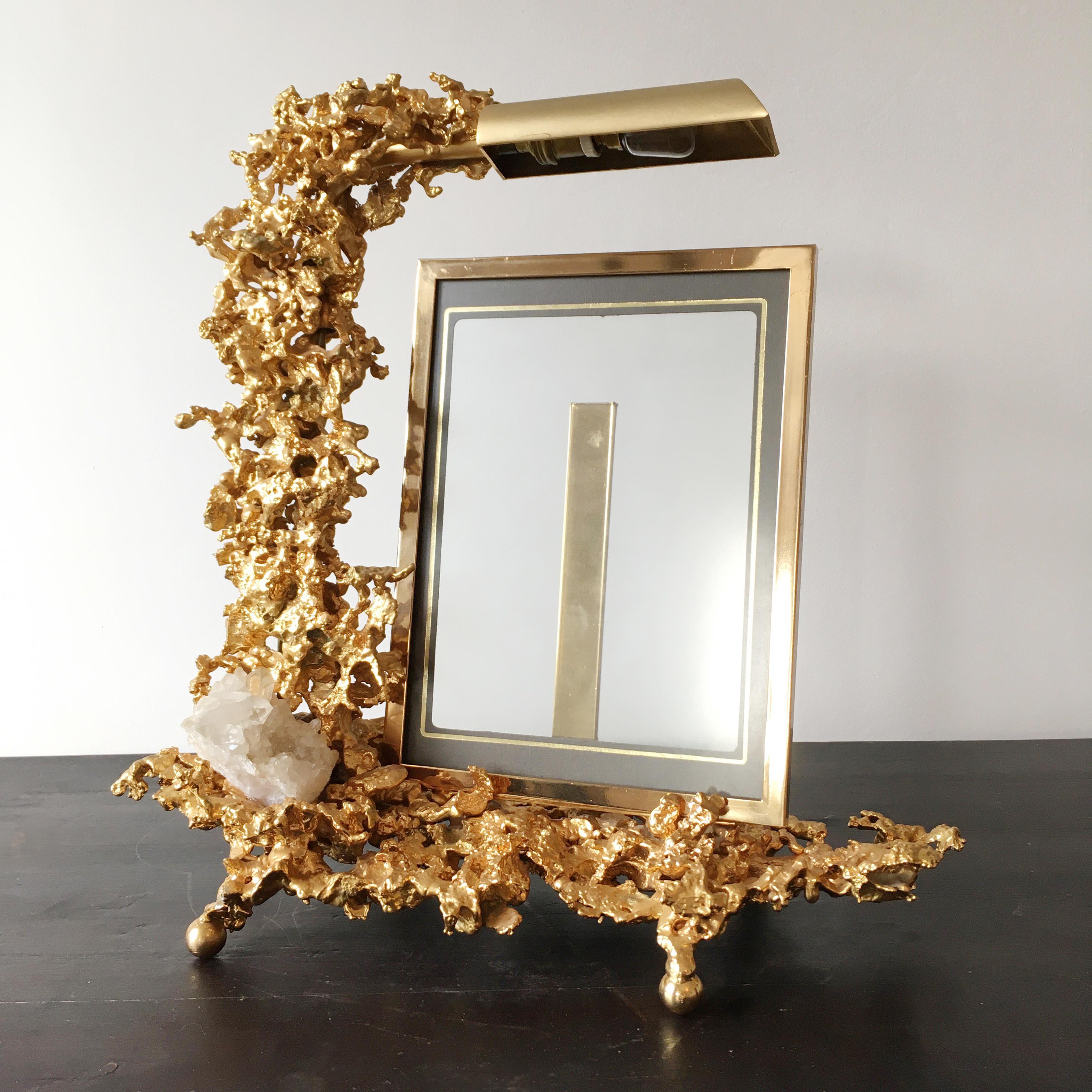 Claude Victor Boeltz sculptural 24-karat gold-plated exploded photograph frame with lamp and rock crystal inclusions.
The natural rock quartz crystal wands are set into the base.
The adjustable lamp head highlights the matching gold-plated