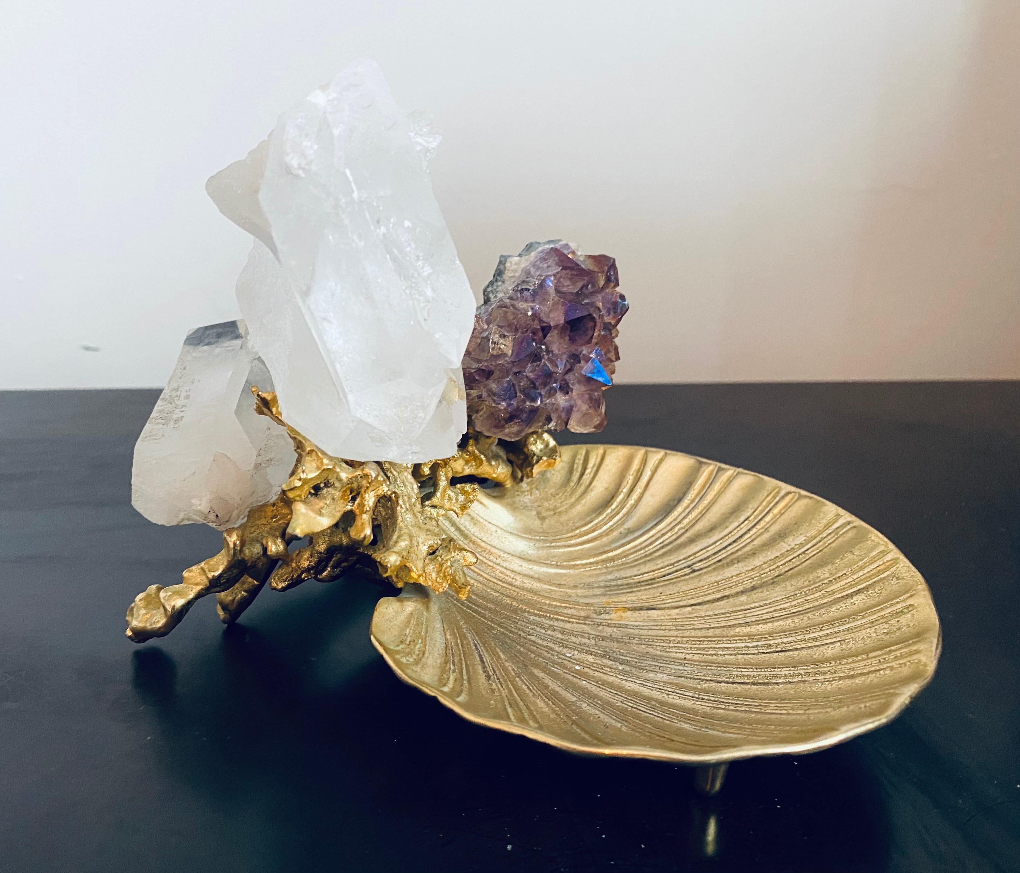 A French 1970s Gold and bronze clam shell center peice sculpture with three large quartz and amethyst crystal clusters. Signed
Biography:
Claude Boeltz was born in Paris in 1937. The fourth generation in a line of artists, from his early childhood