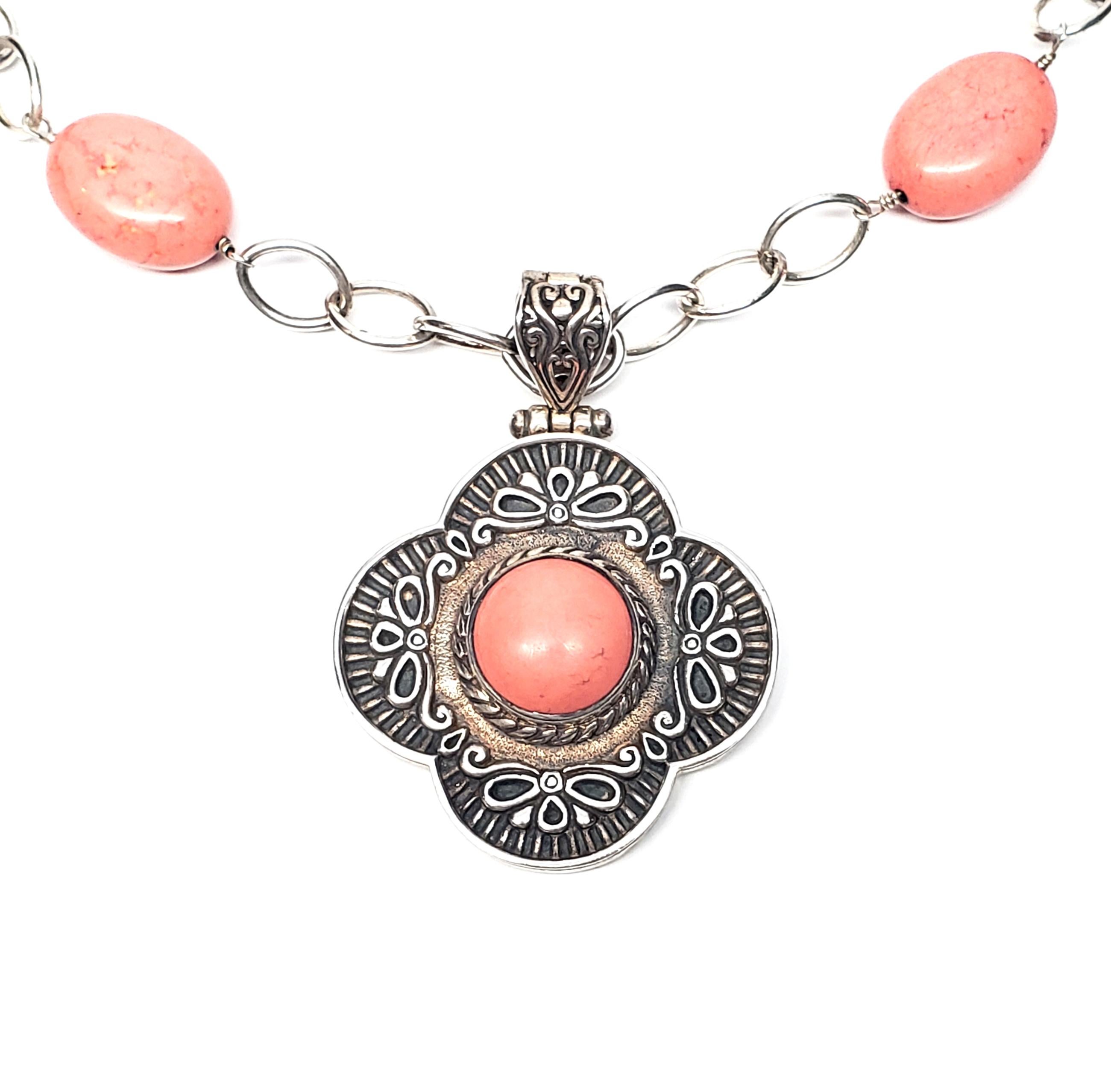 Sterling silver oval link and pink stone necklace with enhancer by Columbian artisan Claudia Agudelo.

Chain features oval sterling silver links alternating with large oval pink cabochon stones. Removable enhancer features a round pink cabochon