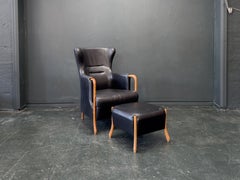 Sillón Highback con reposapiés 'Claudia' de cuero negro y haya by Stouby