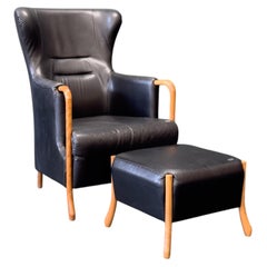 Sillón Highback con reposapiés 'Claudia' de cuero negro y haya by Stouby