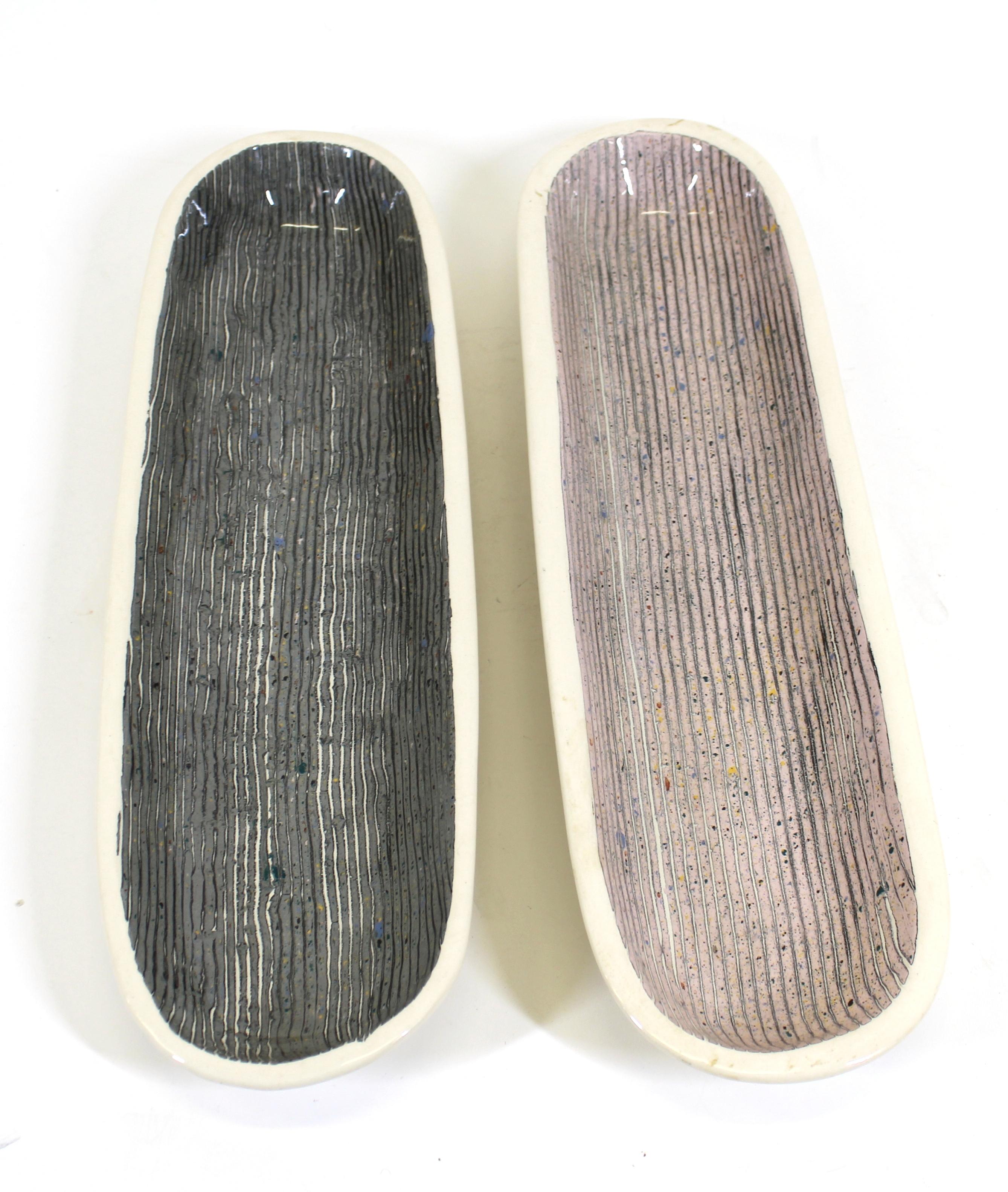 Claudia Reese Postmodern art pottery glazed ceramic elongated pair of vide-poche trays, stamped with makers mark on the side.