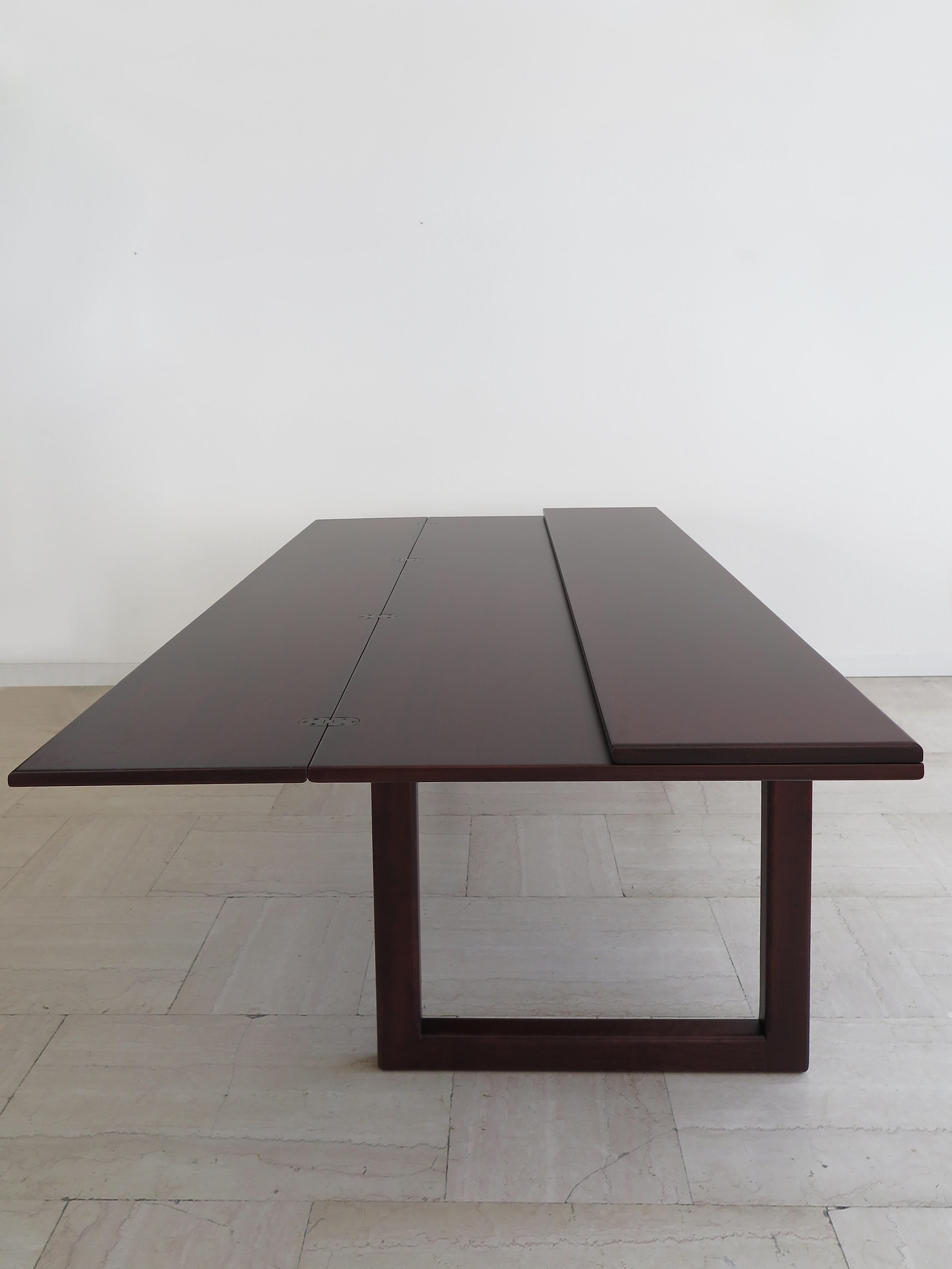 Italian midcentury modern design dining table model SC/66 with extendable rectangular top that can be opened, the table was designed by Claudio Salocchi and manufactured by Sormani, dark wood legs and top, metal frame and details, Italy