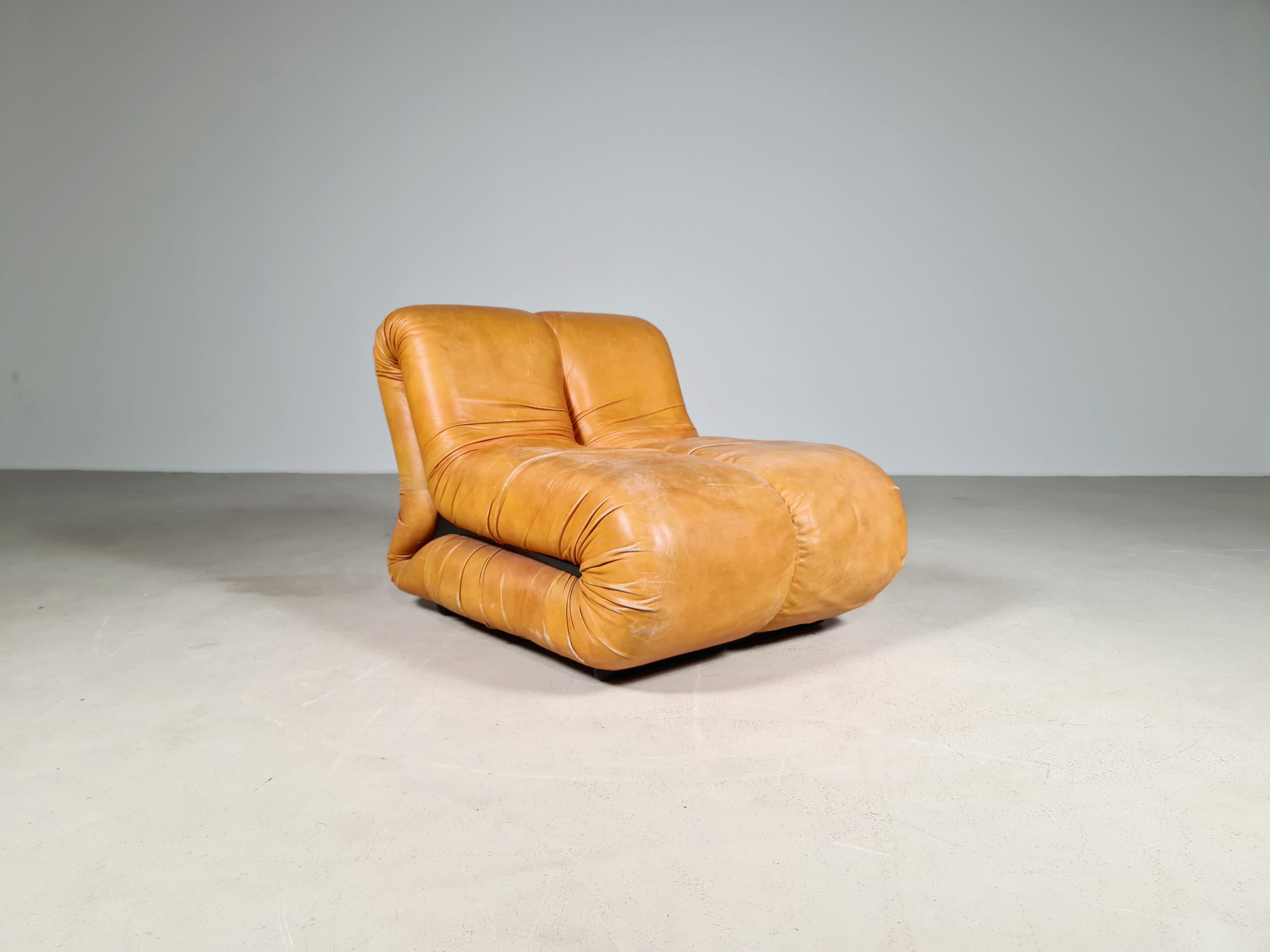 Pagru lounge chair designed in Italy by Claudio Vagnoni, and manufactured by 1P in 1969. The L-shaped forms are attached together which gives it a playful appearance. 
The chair is covered in its original soft light cognac leather. The internal foam