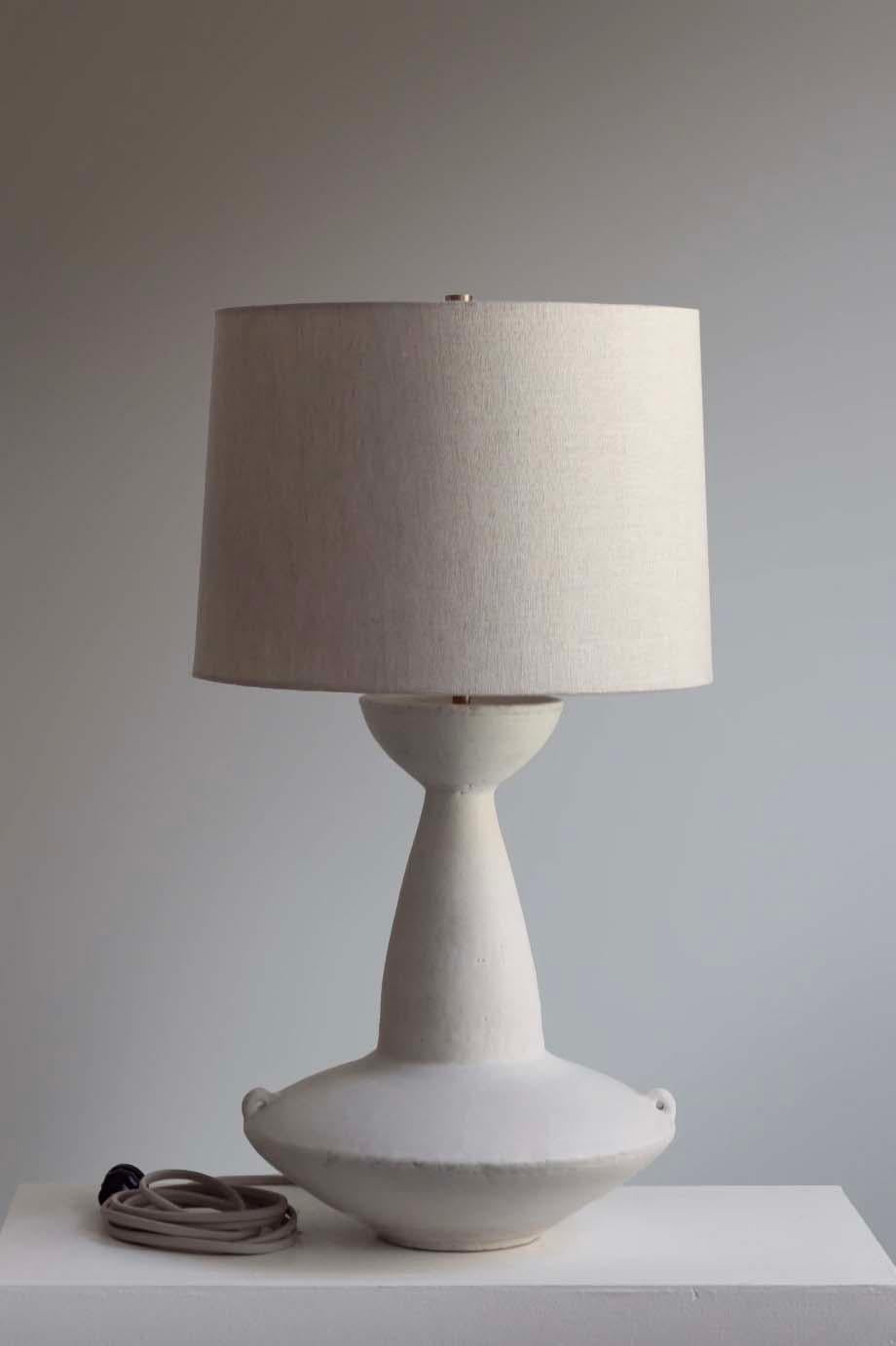 The Claudius lamp is handmade studio pottery by ceramic artist by Danny Kaplan. Shade included. Please note exact dimensions may vary.

Born in New York City and raised in Aix-en-Provence, France, Danny Kaplan’s passion for ceramics was shaped by