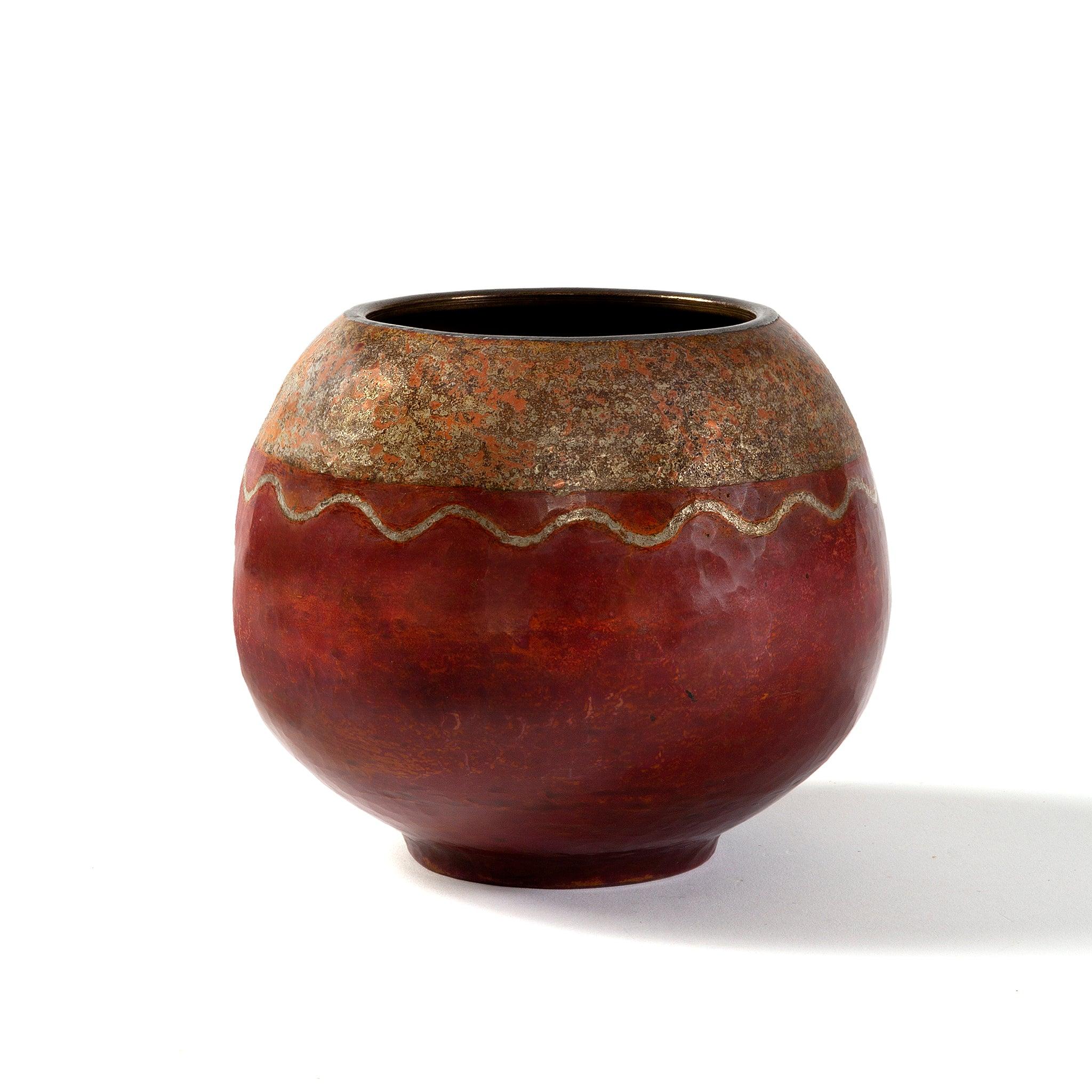 This rare French Art Deco vase, by Claudius Linossier was created using the complex technique known as dinanderie, which involved decorating hand-raised copper vessels to produce subtle but beautiful gradations of color. This spherical vase with an
