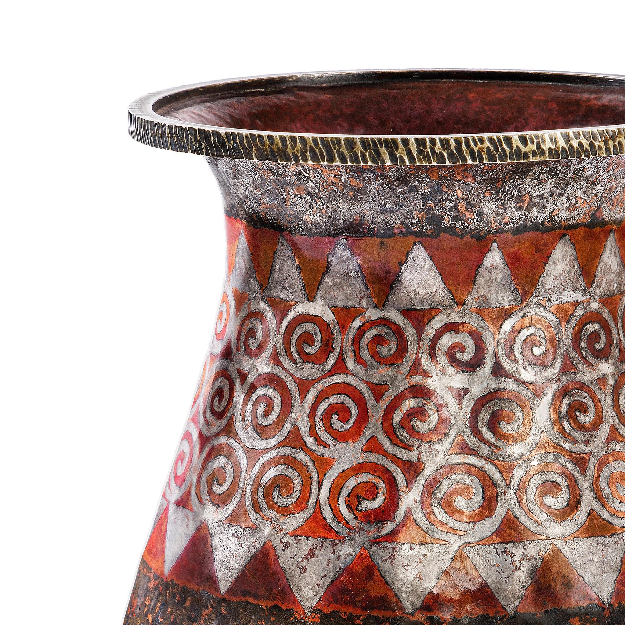 This copper, brass, and silver French Art Deco vase by Claudius Linossier utilizes the dinanderie technique. Using dinanderie, the artist hand-hammers thin sheets of alternating metals to produce subtle gradations of color. The dinanderie technique