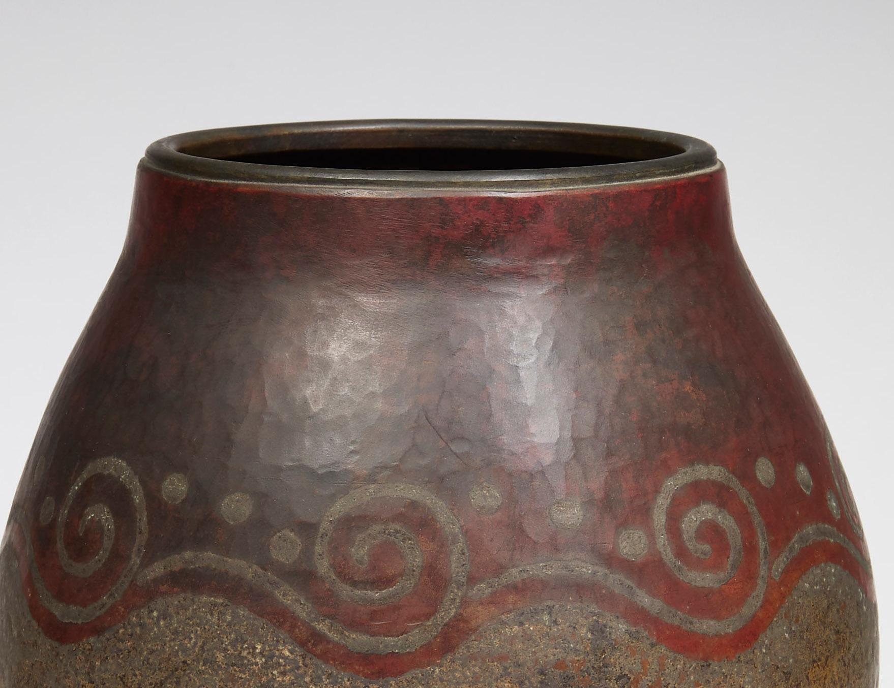 Curved with wide neck vase in copperware with a moiré patina, decorated with ripples and dotted dots made with a fire patina. Signed and numbered 7295 under the base.