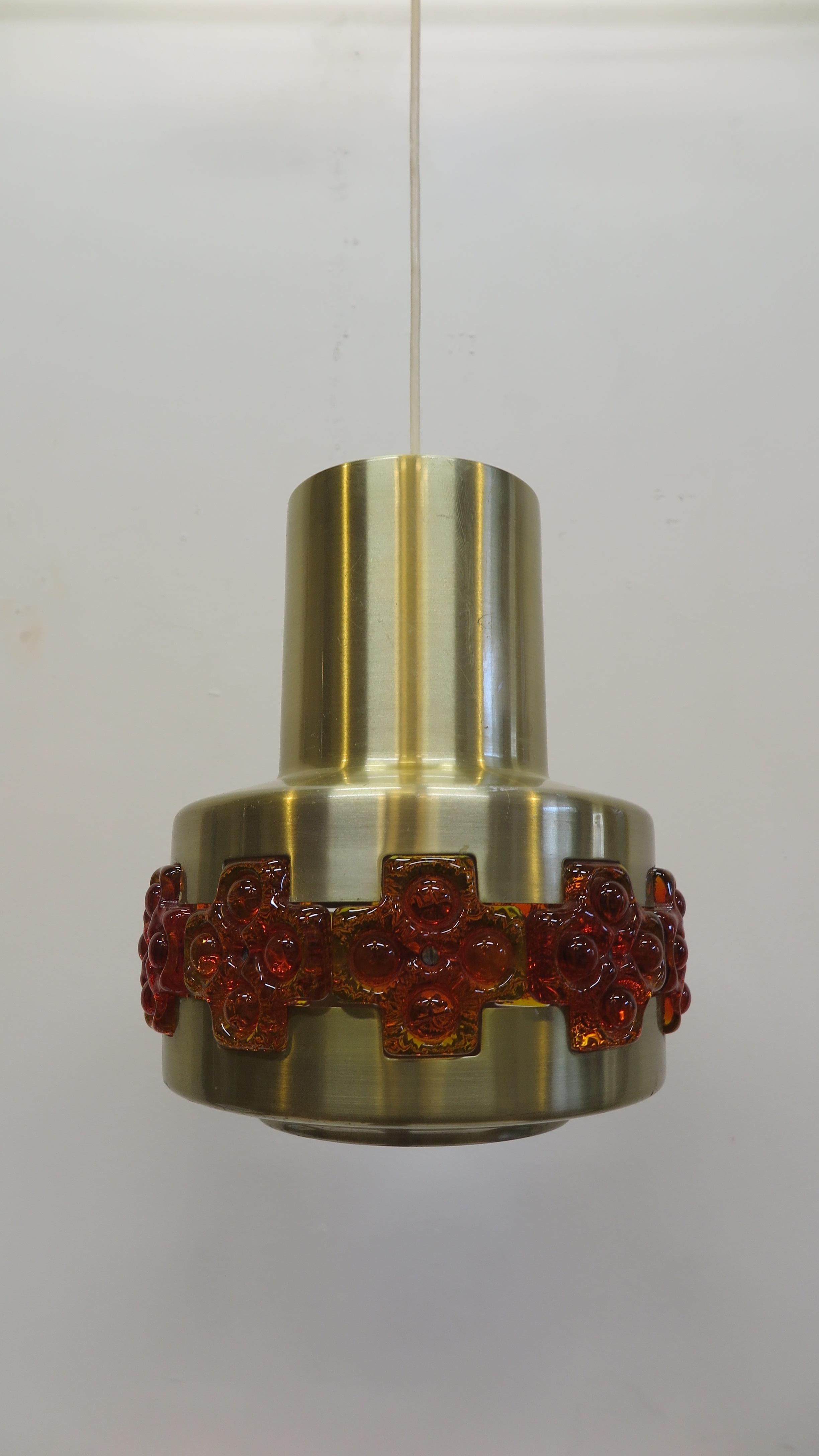 Midcentury pendant lamp by Claus Bolby. Aluminum brass finish with transparent acrylic molded art inlay detail. Beautiful art lamp having glowing of the acrylic when illuminated.
With the current cord height or hanging length is adjustable from 20