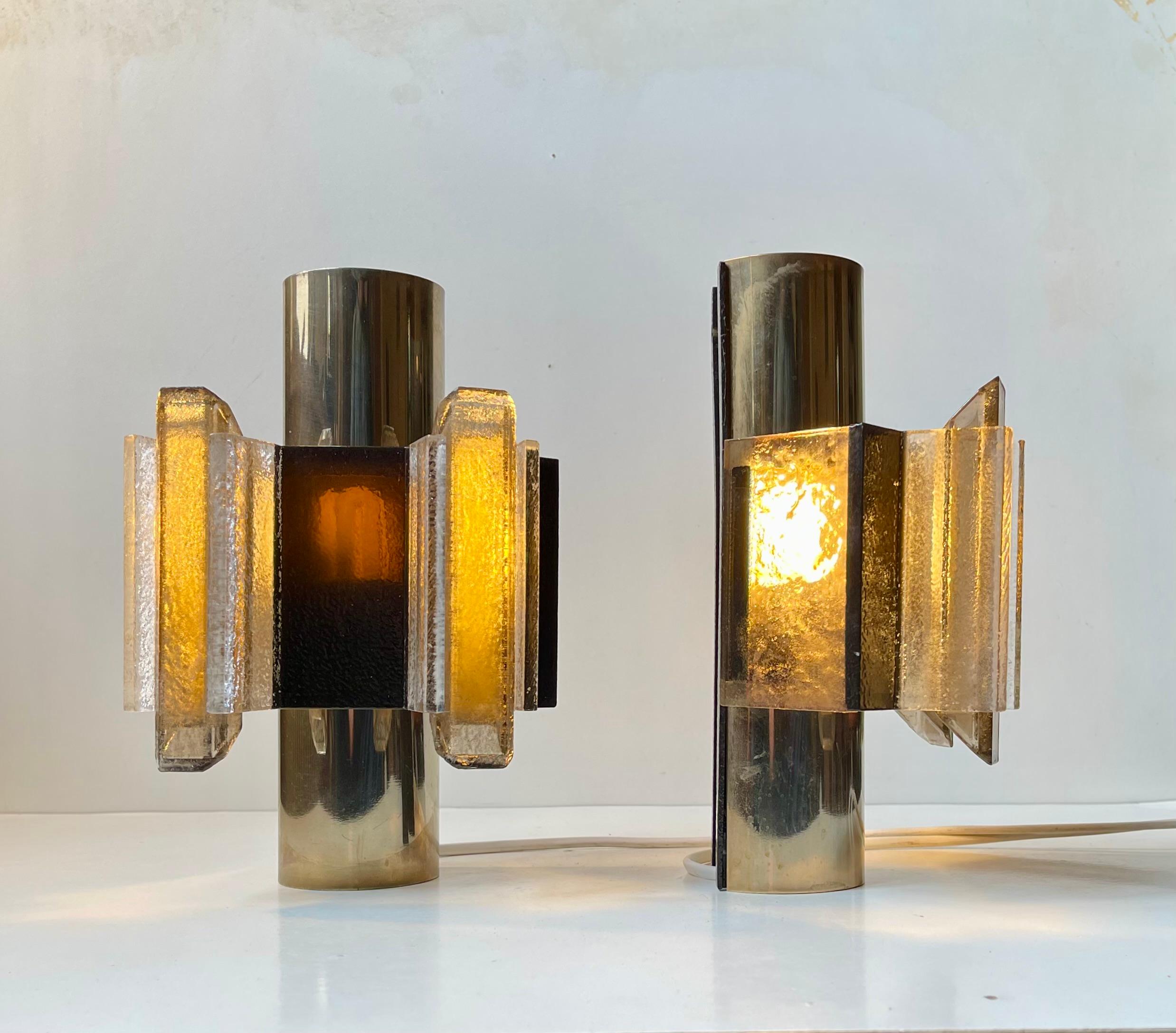 A rare pair of Danish Space Age or Brutalist wall lamps designed by Claus Bolby and manufactured by his own lighting company Cebo Industri in Silkeborg, Denmark in the late 60s to early 70s. The lamps are hand-made from layered strips of smooth