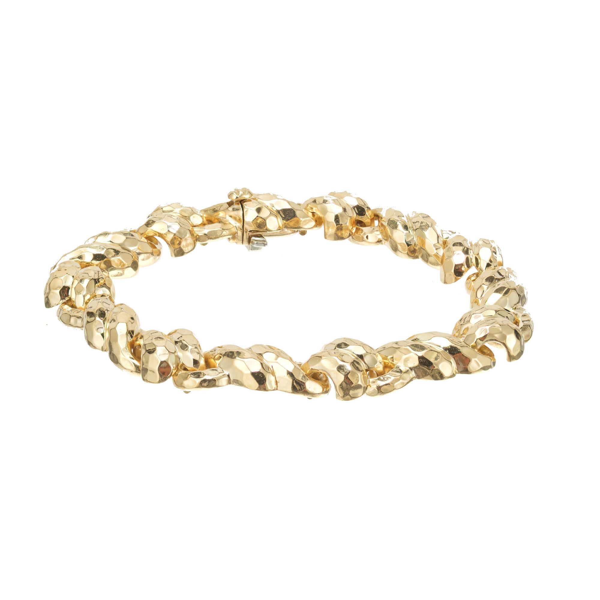 Shiny textured solid 18k yellow gold link bracelet by jeweler artist and designer Claus Vollrath. Built in catch and underside safety. 
German born Claus Vollrath was trained in his native country which led him to Cartier and later opening his own