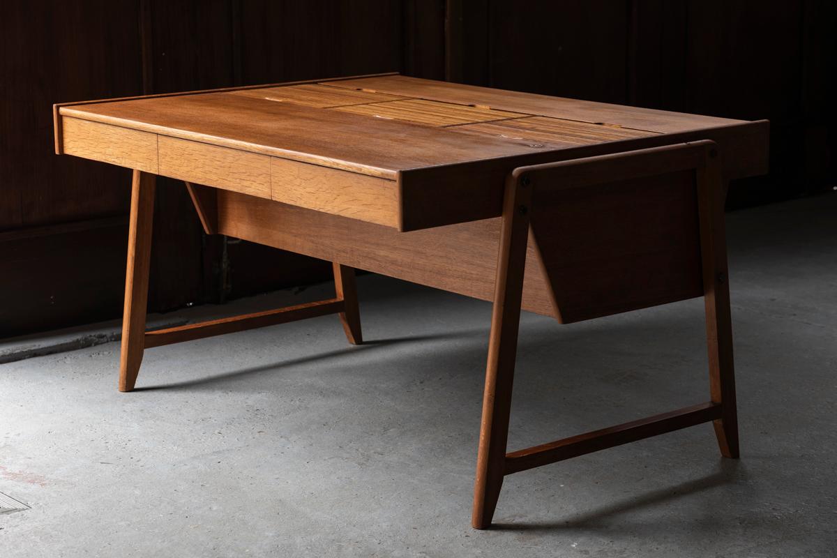 Writing desk designed by Clausen & Maerus for Eden in the Netherlands around 1960. Well-crafted desk in solid oak and oak veneer with 3 large storage units on top which can be closed with tambour doors. The key is missing but further in good