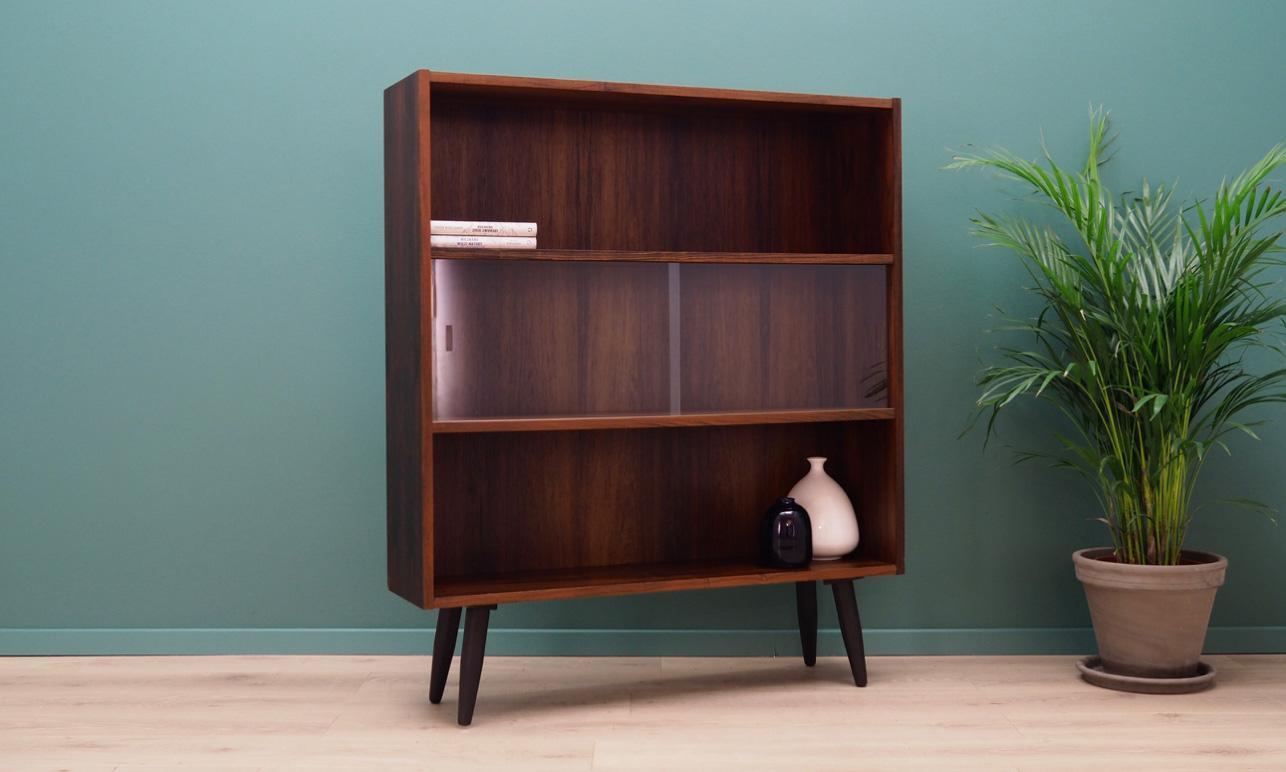 Classic bookcase, library from the 1960s-1970s. Scandinavian design, Minimalist form. Manufactured by Clausen & Son. Furniture finished with rosewood veneer. The shelf has a glass sliding door. Maintained in good condition (minor bruises and