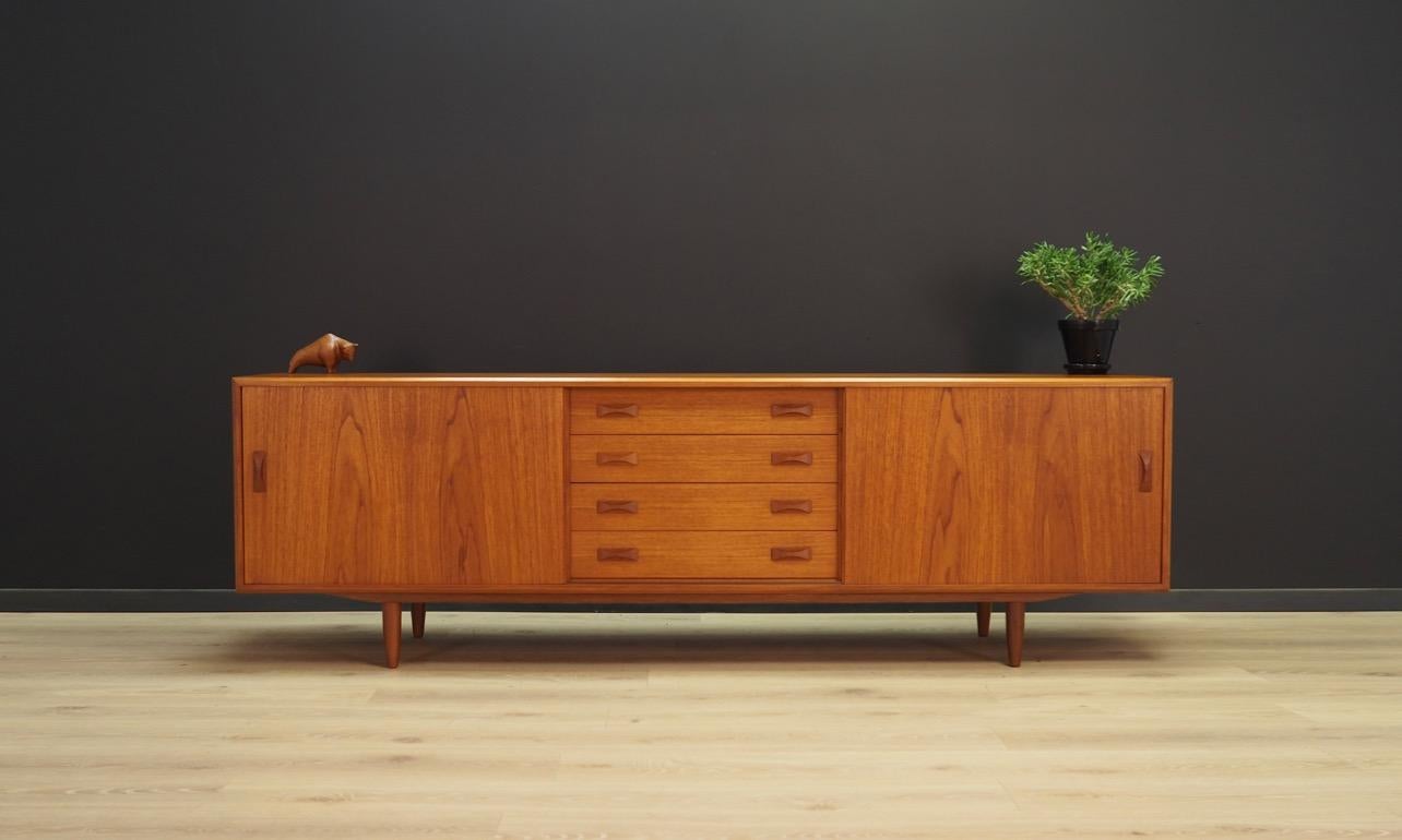 Classic 1960s-1970s sideboard - a minimalistic, beautiful design. Produced by CLAUSEN & SON. Surface finished with teak veneer. Capacious space with shelves behind the sliding doors and four drawers in the middle. Preserved in good condition (minor