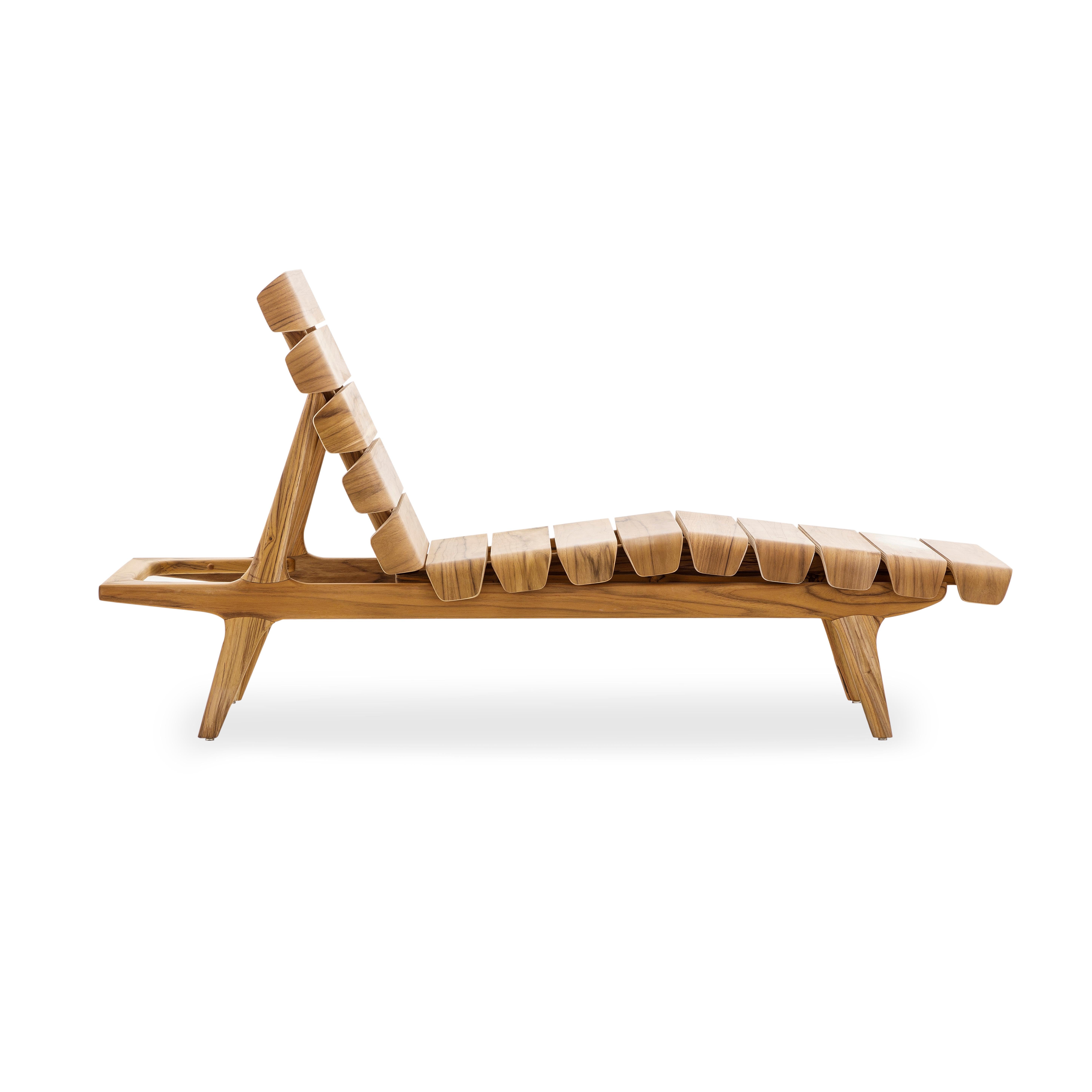 The Clave indoor chaise lounge in a monochromatic teak wood Uultis finish, all made from wood, is the perfect addition for any contemporary, minimalist, or traditional design project. This chaise is the ideal chair to relax and lounge with its