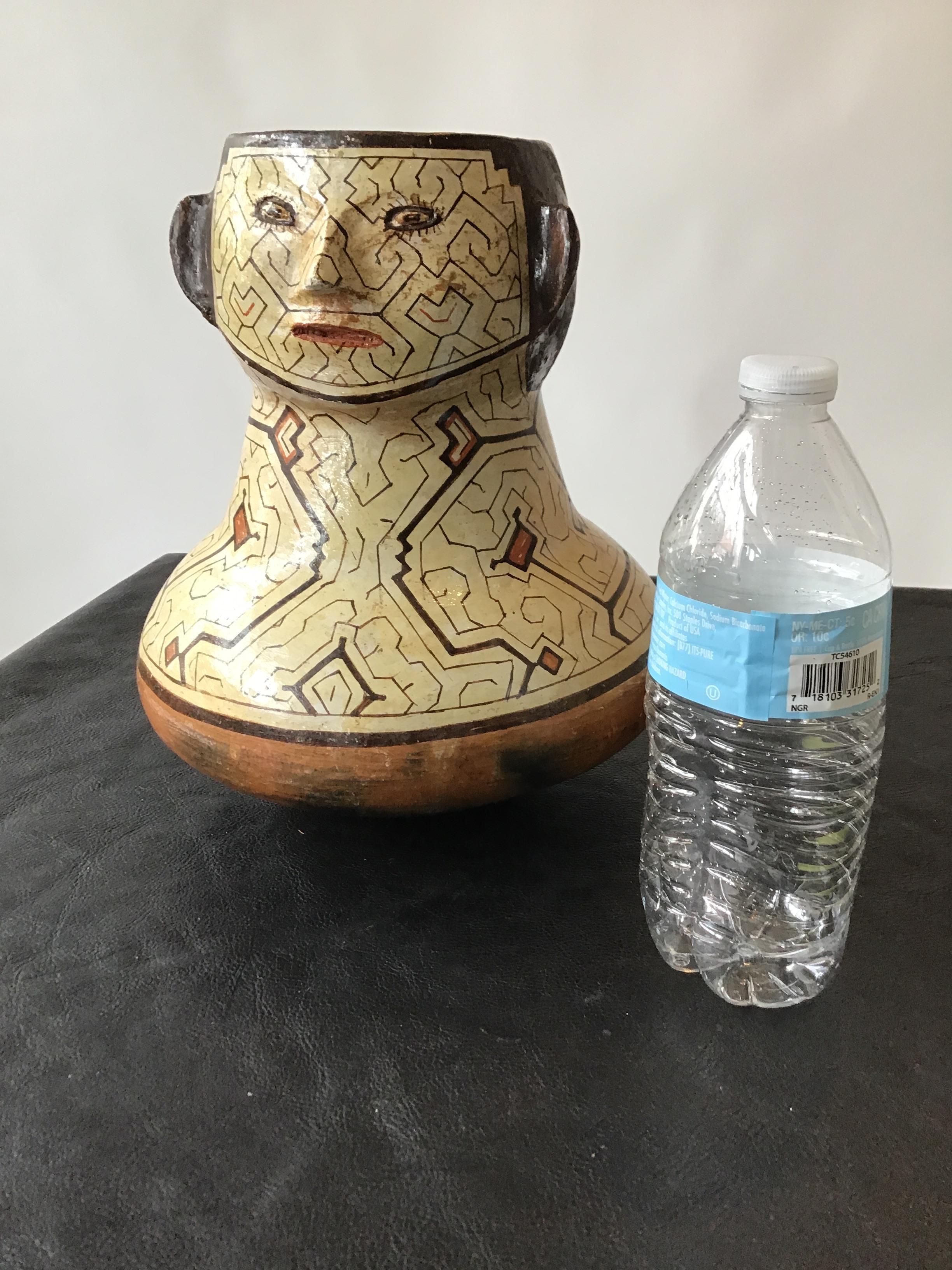 Shipibo Peruvian face vase. Hand painted clay .