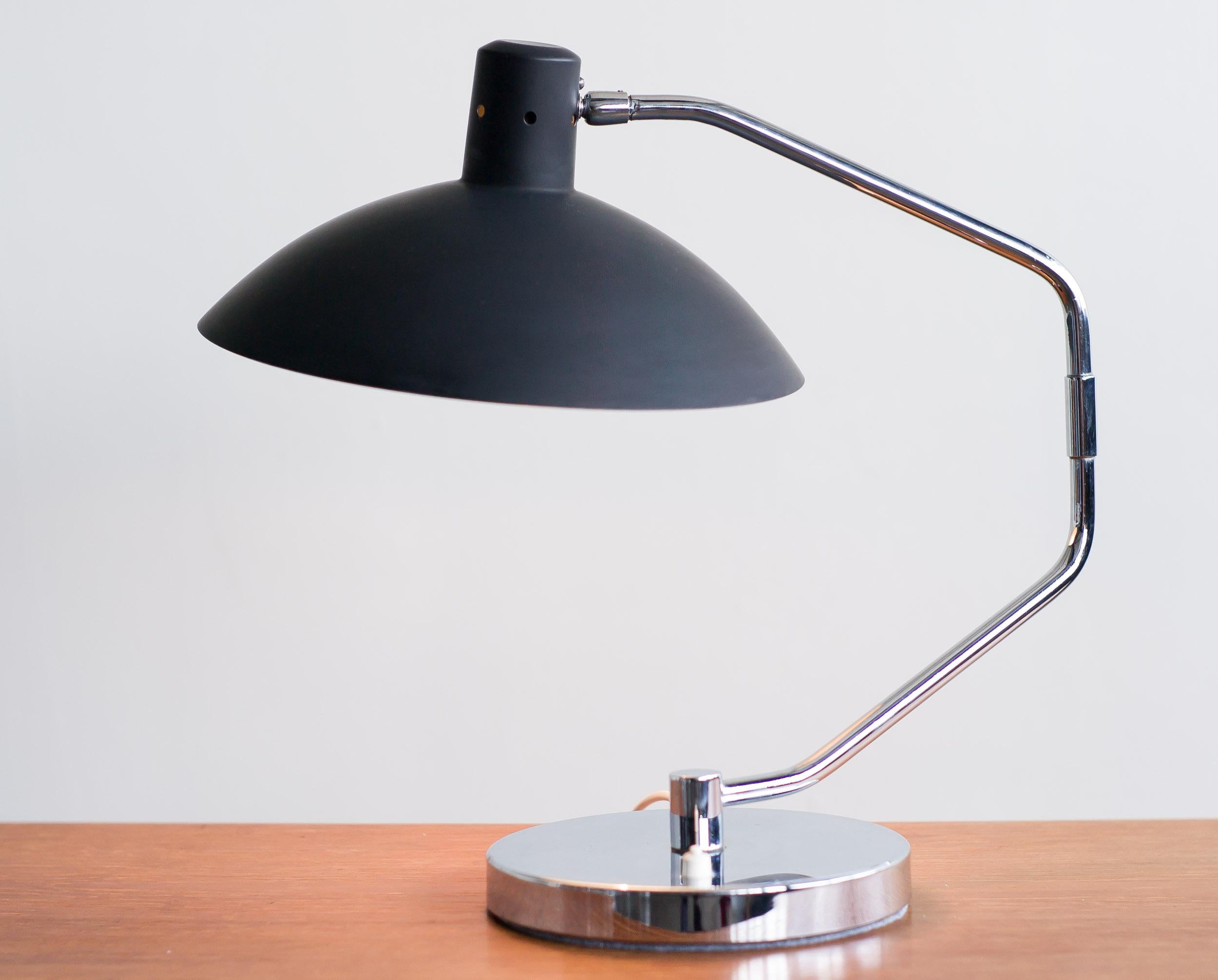 Iconic swing arm desk lamp model no. 8, designed by Clay Michie in 1958 and manufactured by Knoll International.
Nice vintage condition. The original black lacquer changed to a slightly dull charcoal color from age. 
The chrome base has a slight