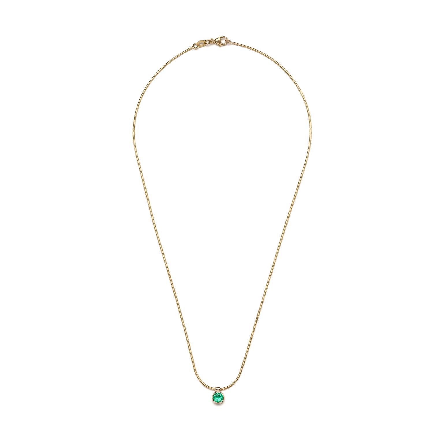 A bright bluish green emerald is the main focus of the Clea Necklace. A slinky 14k yellow gold snake chain follows the shape of your neck, for a comfortable look and feel.

Emerald is 5mm / 0.5 carats
14k yellow gold chain in 15'' (pictured). Also