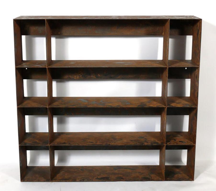 Clean lined architectural metal bookshelf, American, circa 1980s. Retains its wonderful original overall oxidized patina. It is a versatile size and can be used as a bookcase or bookshelf, vitrine, or media cabinet.