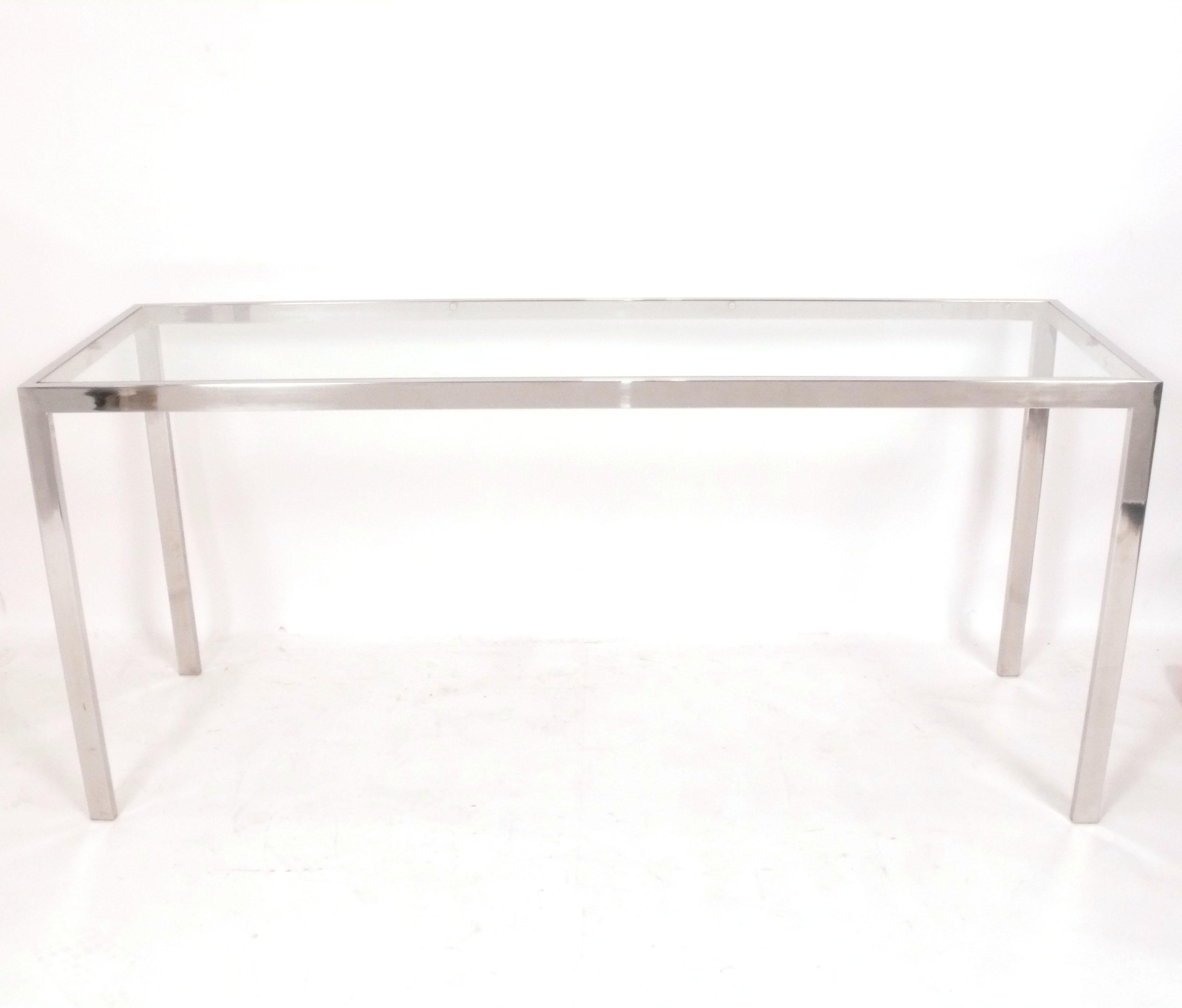Clean Lined Mid Century Chrome Console Table, in the manner of Florence Knoll or Milo Baughman, American, circa 1960s. It is a versatile size and can be used as a console table, sofa table, desk, vanity, or bar. 