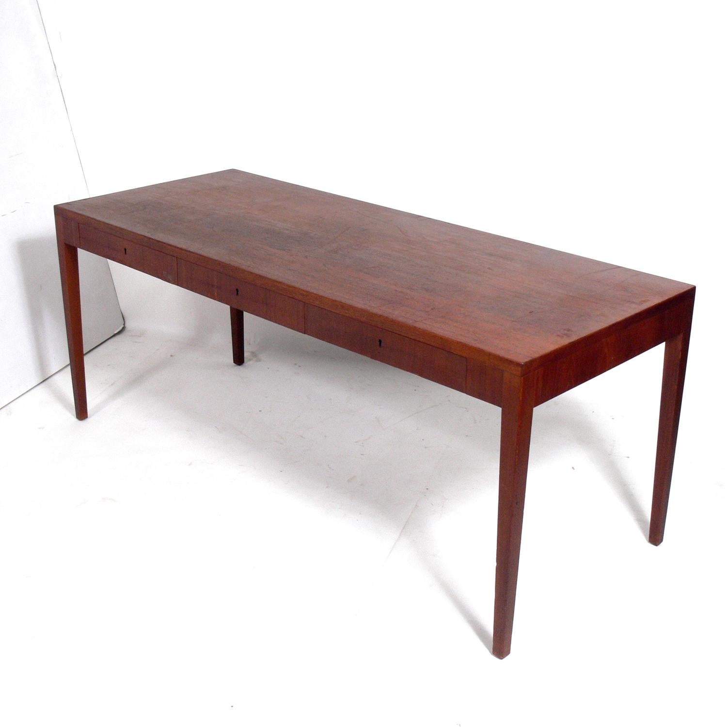 Clean lined Danish modern teak desk, designed by, branded underneath, Denmark, circa 1960s. This desk is currently being refinished and will look wonderful when completed.