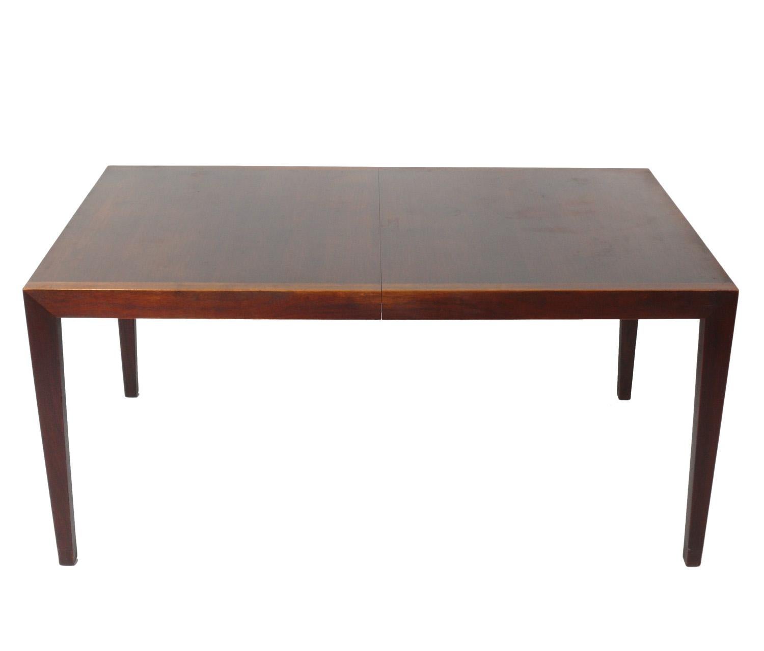 Clean lined walnut dining table, designed by Florence Knoll for Knoll, American, circa 1950s. Signed with early Knoll label underneath. It has been cleaned and Danish oiled. It measures an impressive 60