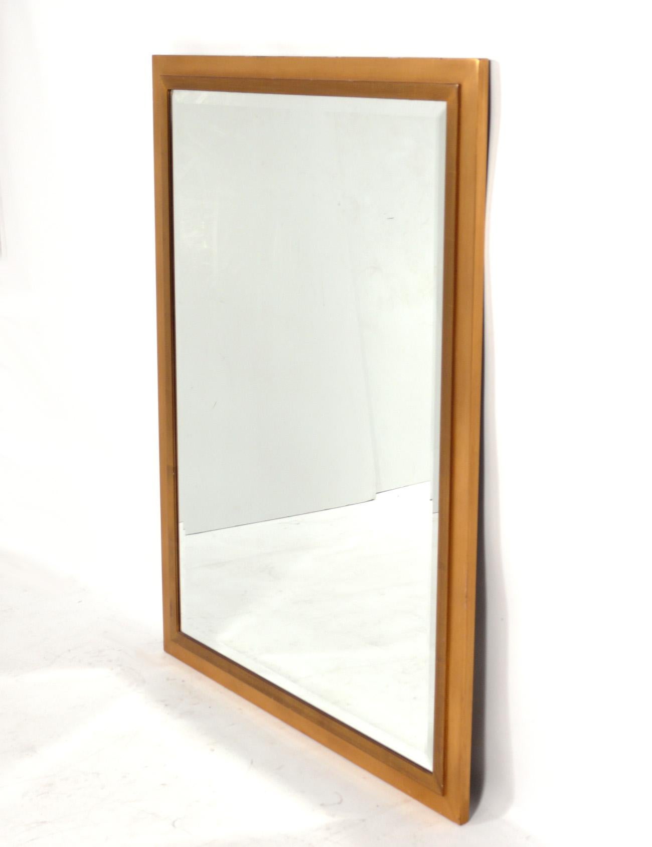 Clean lined gilt wood mirror, American, circa 2000s. This mirror was recently removed from the storied Carlyle Hotel in NYC. It measures an impressive 48