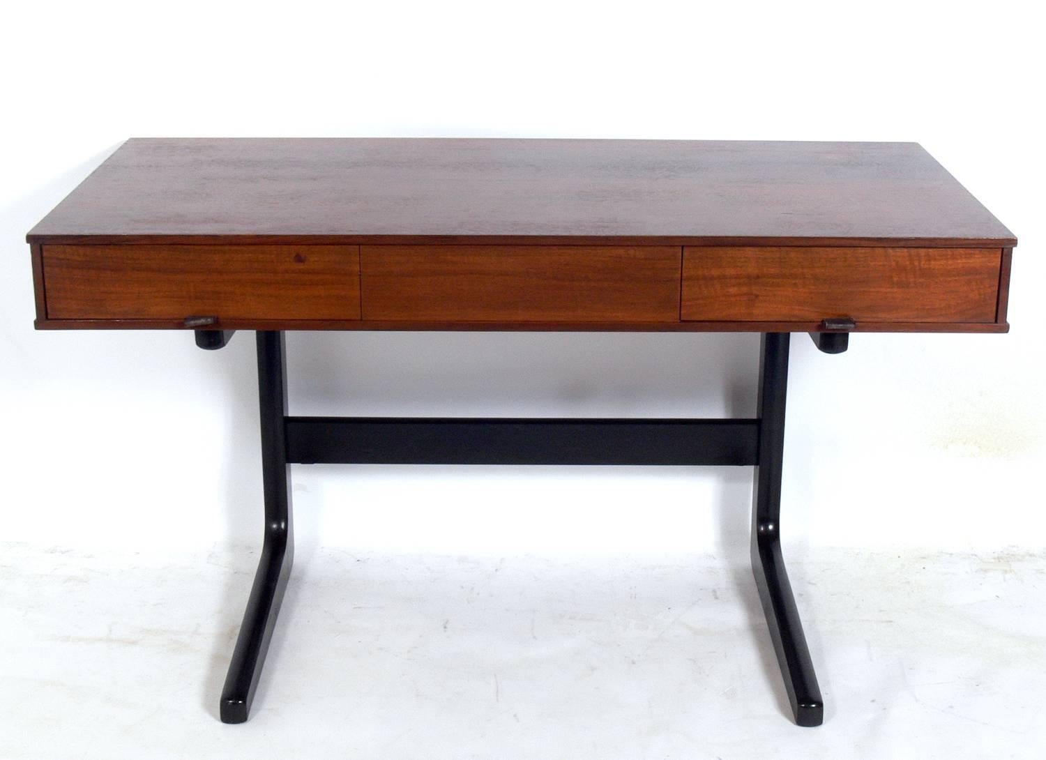 Clean lined midcentury desk with leather pulls, believed to be American, circa 1950s.