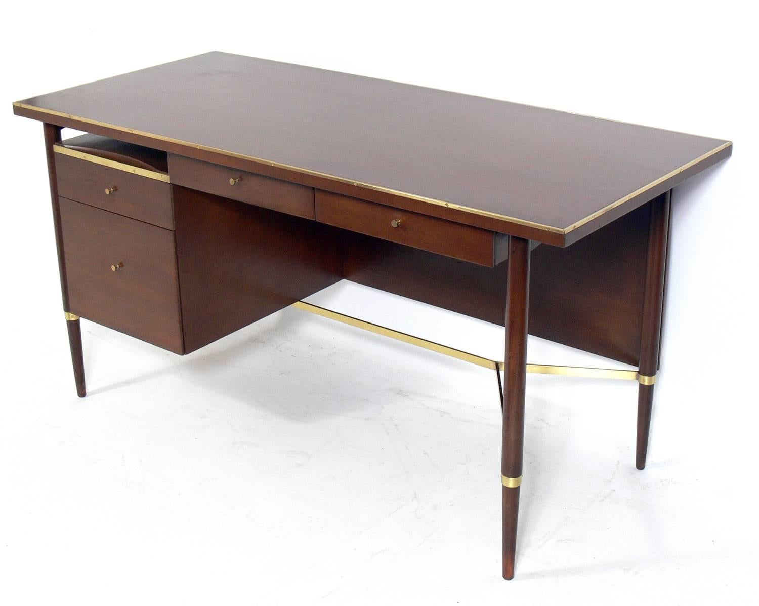 Clean lined modern desk, designed by Paul McCobb, American, circa 1960s. This desk is currently being refinished and can be completed in your choice of finish color. The price noted includes refinishing in your choice of finish color.