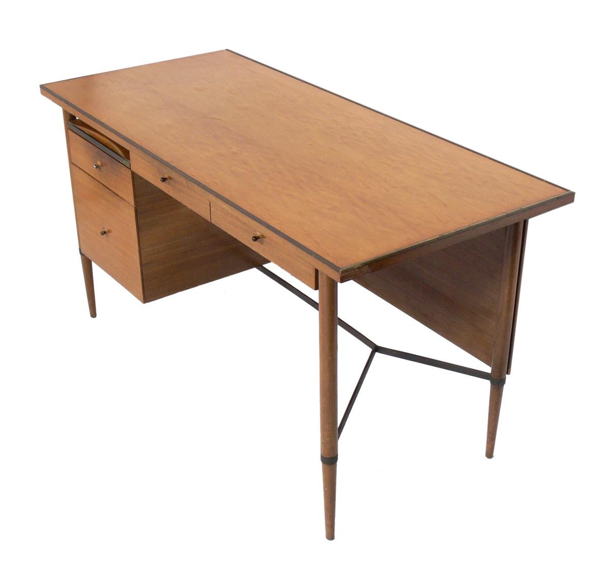 Clean lined modern desk, designed by Paul McCobb for The Connoisseur collection for H. Sacks, American, circa 1950s. This desk is currently being refinished and can be completed in your choice of finish color. The price noted includes refinishing in