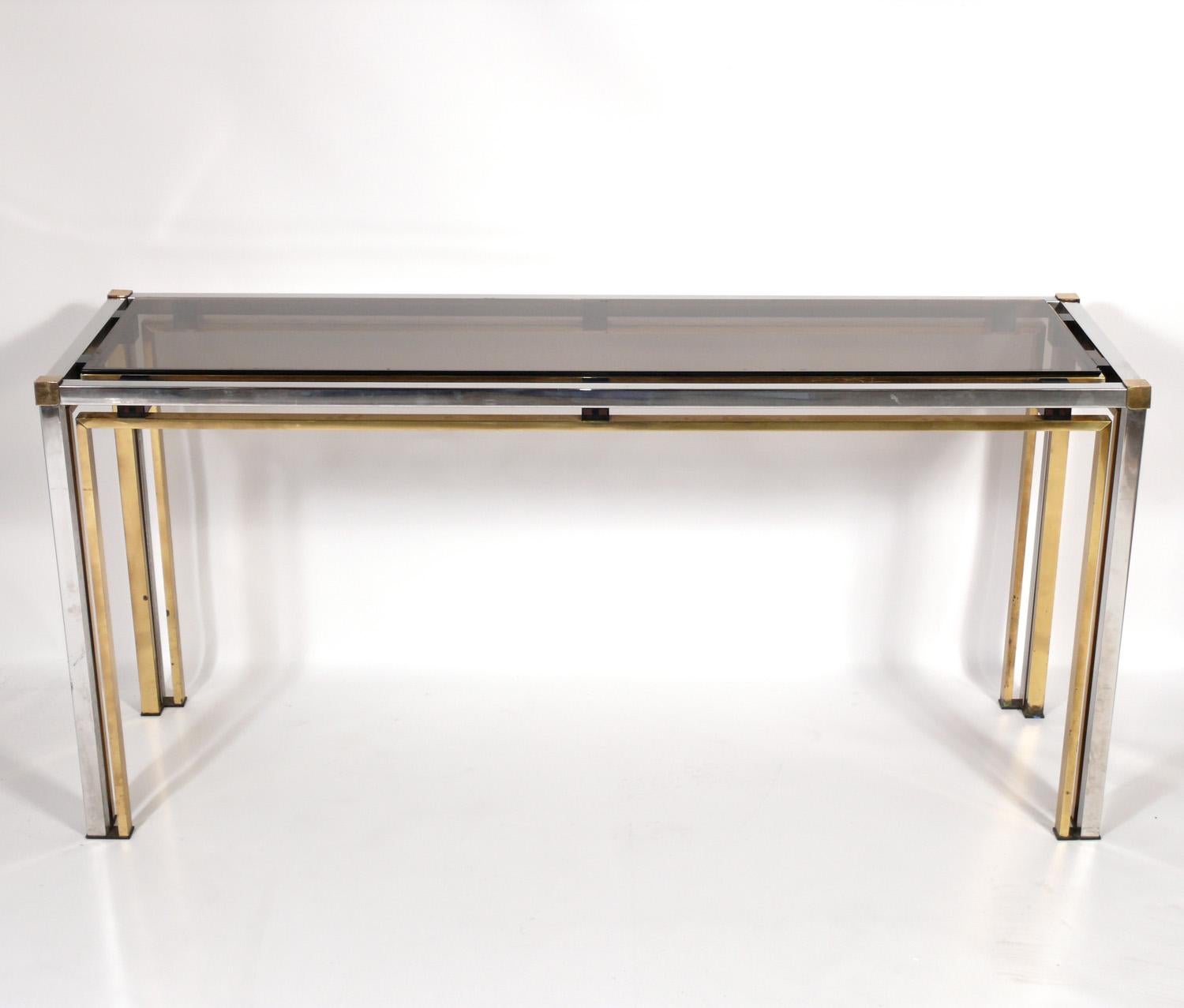 Clean Lined Modern Italian Brass and Chrome Console or sofa table, in the manner or Romeo Rega, Italy, circa 1970s. This table is a versatile size and can be used as a console table, sofa table, desk, or vanity.