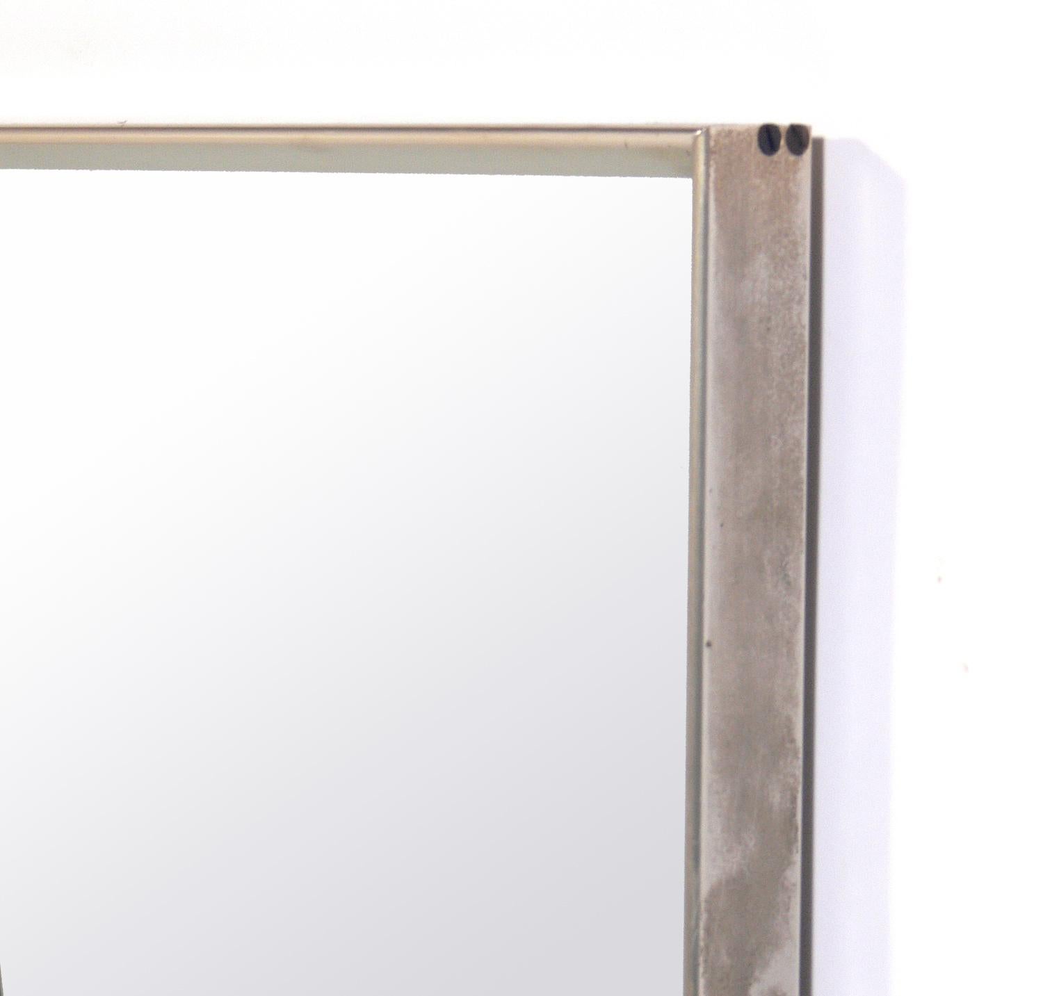 Clean lined nickel midcentury mirror, American, circa 1950s. Clean lined design with nice attention to detail, including interesting corner joinery. Retains warm original patina.