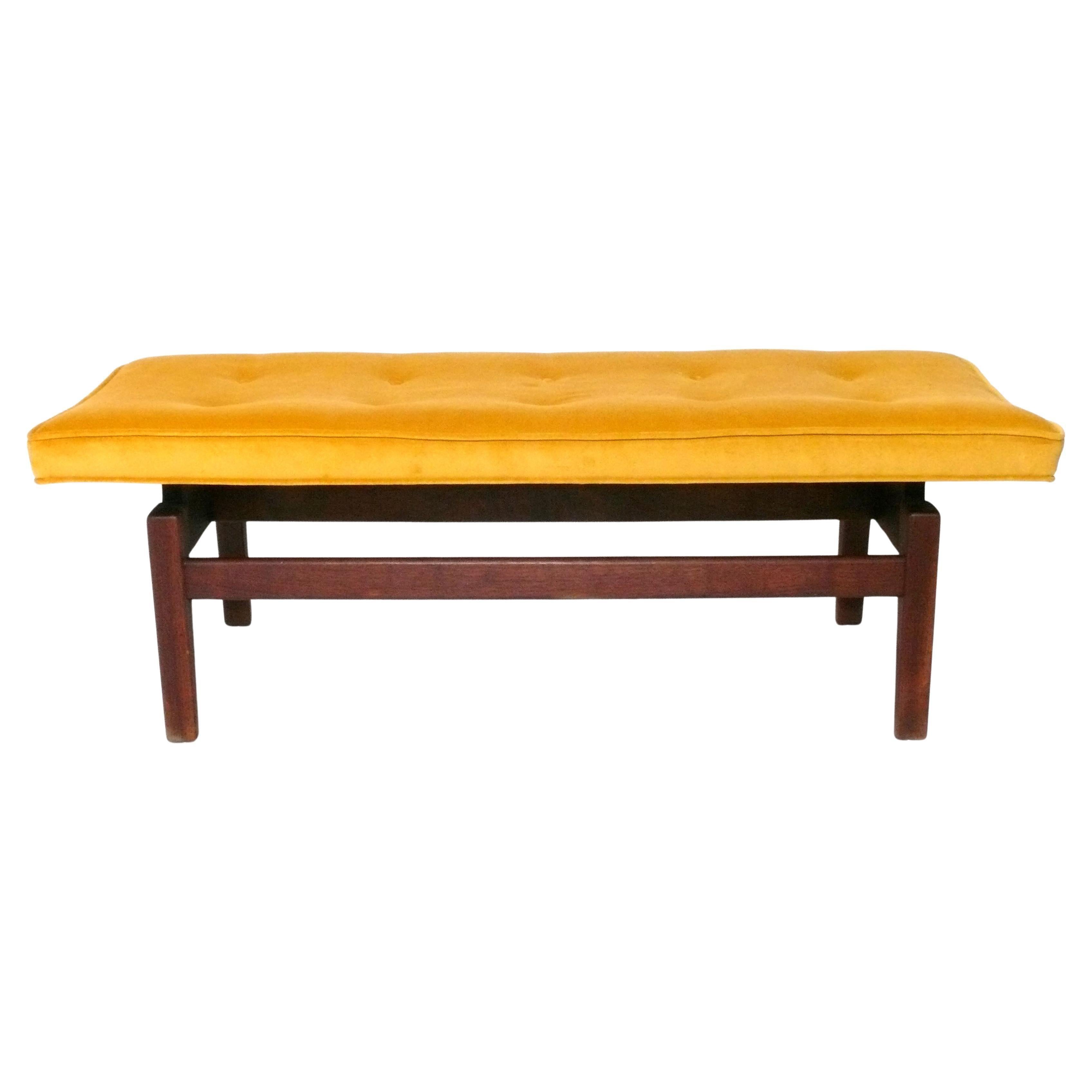 Clean Lined Mid Century Modern Bench, designed by Jens Risom, American, circa 1960s. It has been recently reupholstered in a saffron yellow color velvety fabric. The walnut frame has been cleaned and Danish oiled. 
