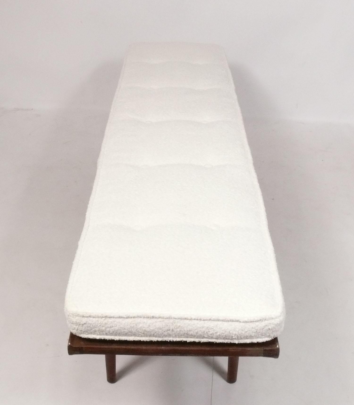 Clean lined midcentury walnut bench, designed by Kipp Stewart for Drexel, American, circa 1950s. It is a versatile size and can be used as a coffee table or bench. Beautiful graining to the walnut top. Reupholstered in an ivory color boucle fabric.