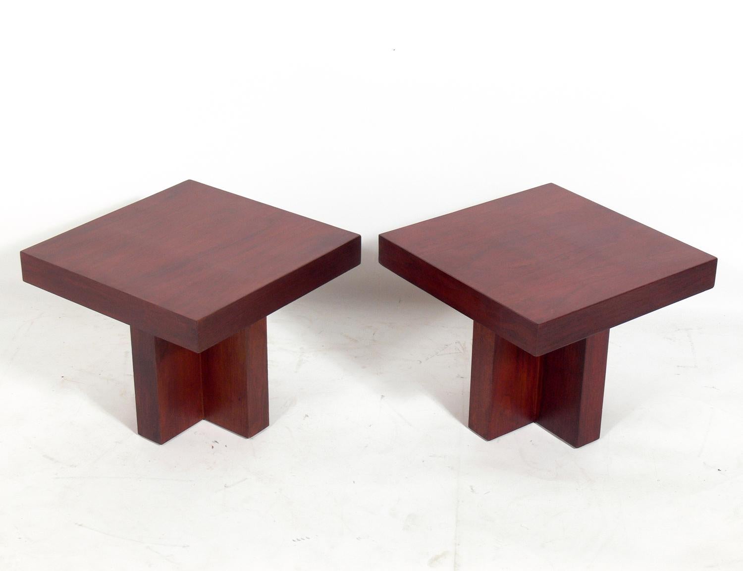 Pair of clean lined walnut end tables, in the style of  Milo Baughman, American, circa 1960s. These tables have a clean lined architectural design and can be used as end or side tables, nightstands, or pushed together to be used as a coffee table.