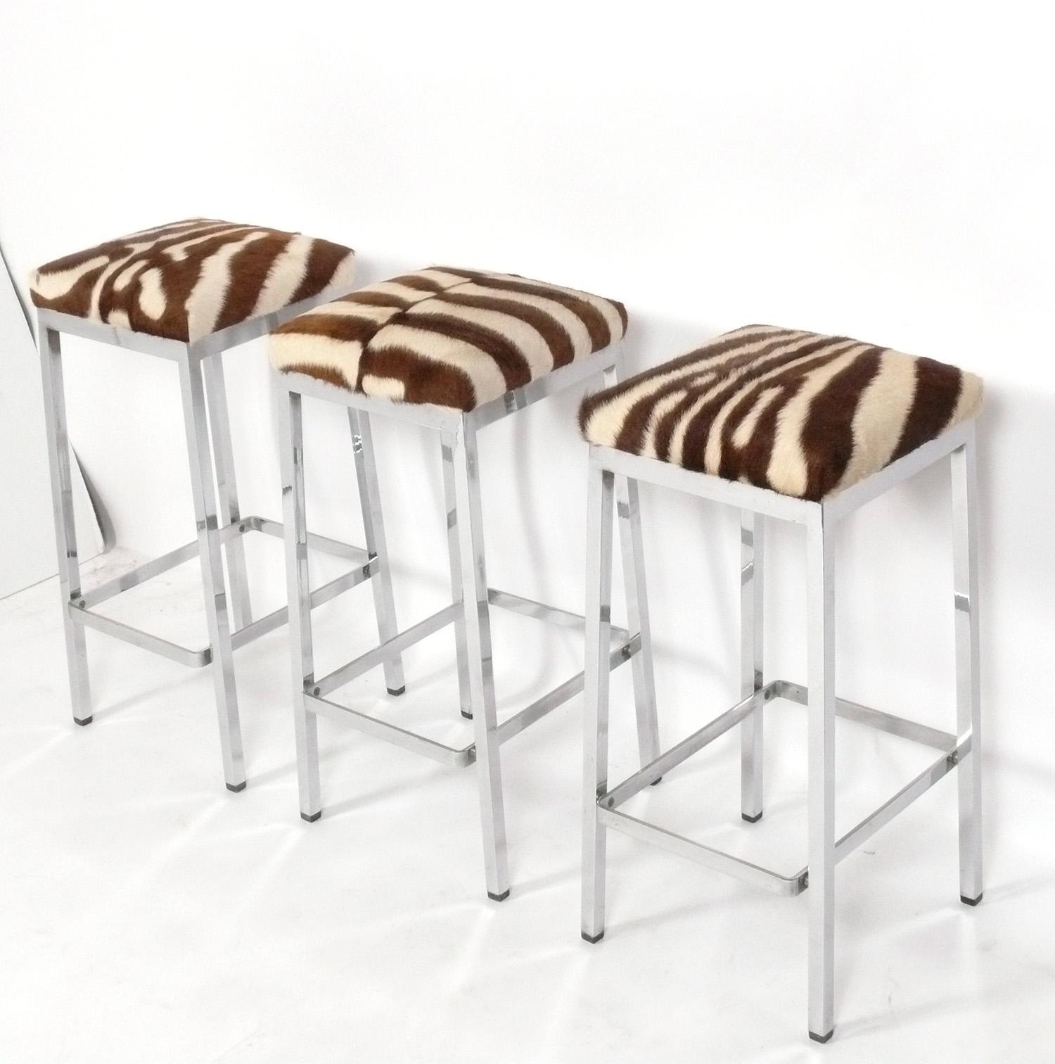 Set of Three Clean Lined Chrome and Zebra Hide Bar Stools, American, circa 1960s. They measure 30