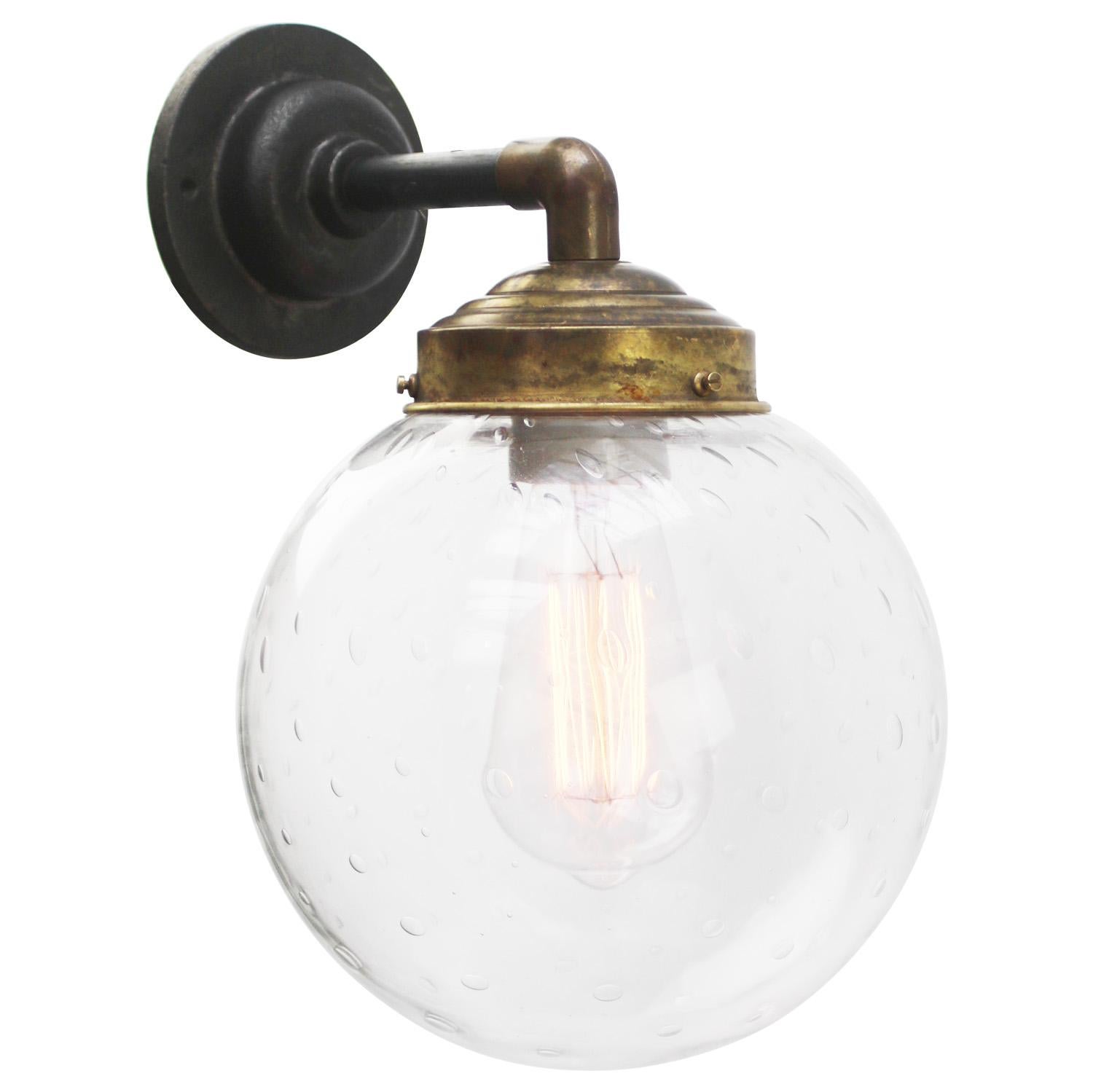 Brass and cast Iron Industrial wall light 
clear air bubble glass globe

Diameter cast iron wall piece: 10.5 cm / 4”, 2 holes to secure

Weight: 2.50 kg / 5.5 lb

Priced per individual item. All lamps have been made suitable by international