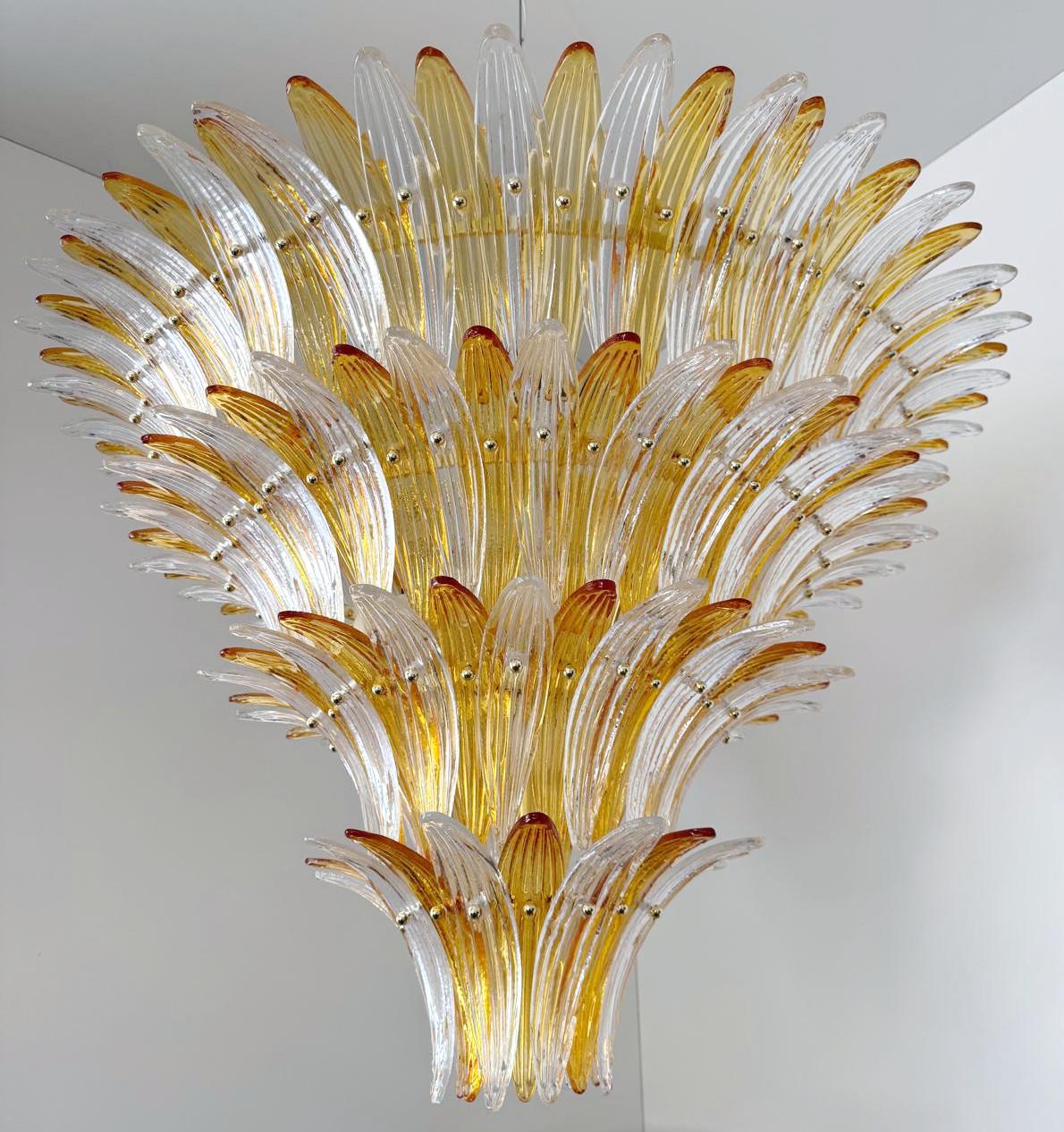 Italian Palmette chandelier with clear and amber Murano glass leaves mounted on gold finish metal frame / Made in Italy
Diameter: 43.5 inches / Height: 27.5 inches plus chain and canopy
12 lights / E26 or E27 type / max 60W each
1 available in stock