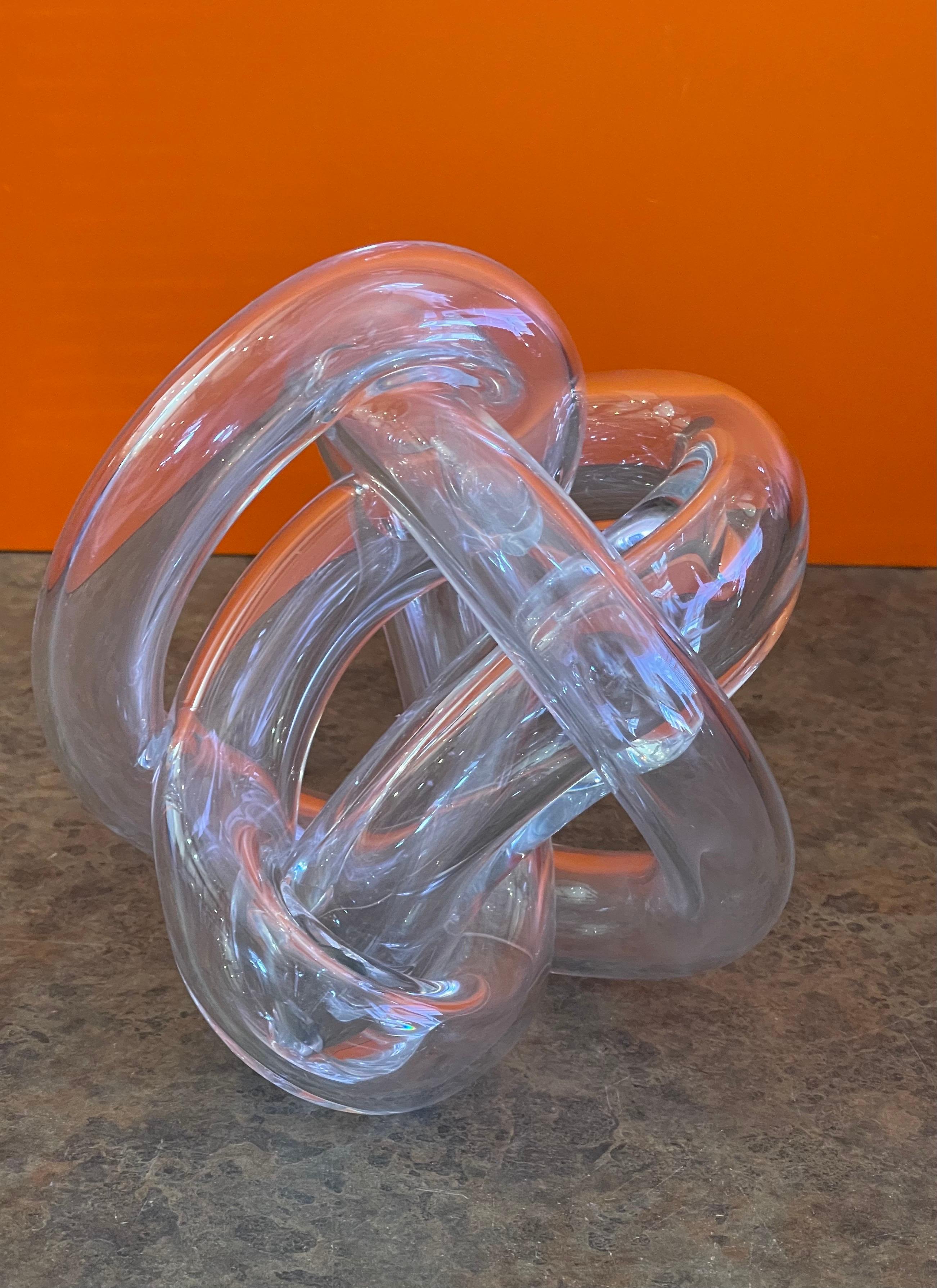 Large clear art glass orb / knot sculpture, circa 1980s. This Italian hand blown glass orb has a biomorphic free form design and is in very good condition with no chips or cracks. The piece is approximately 7.5