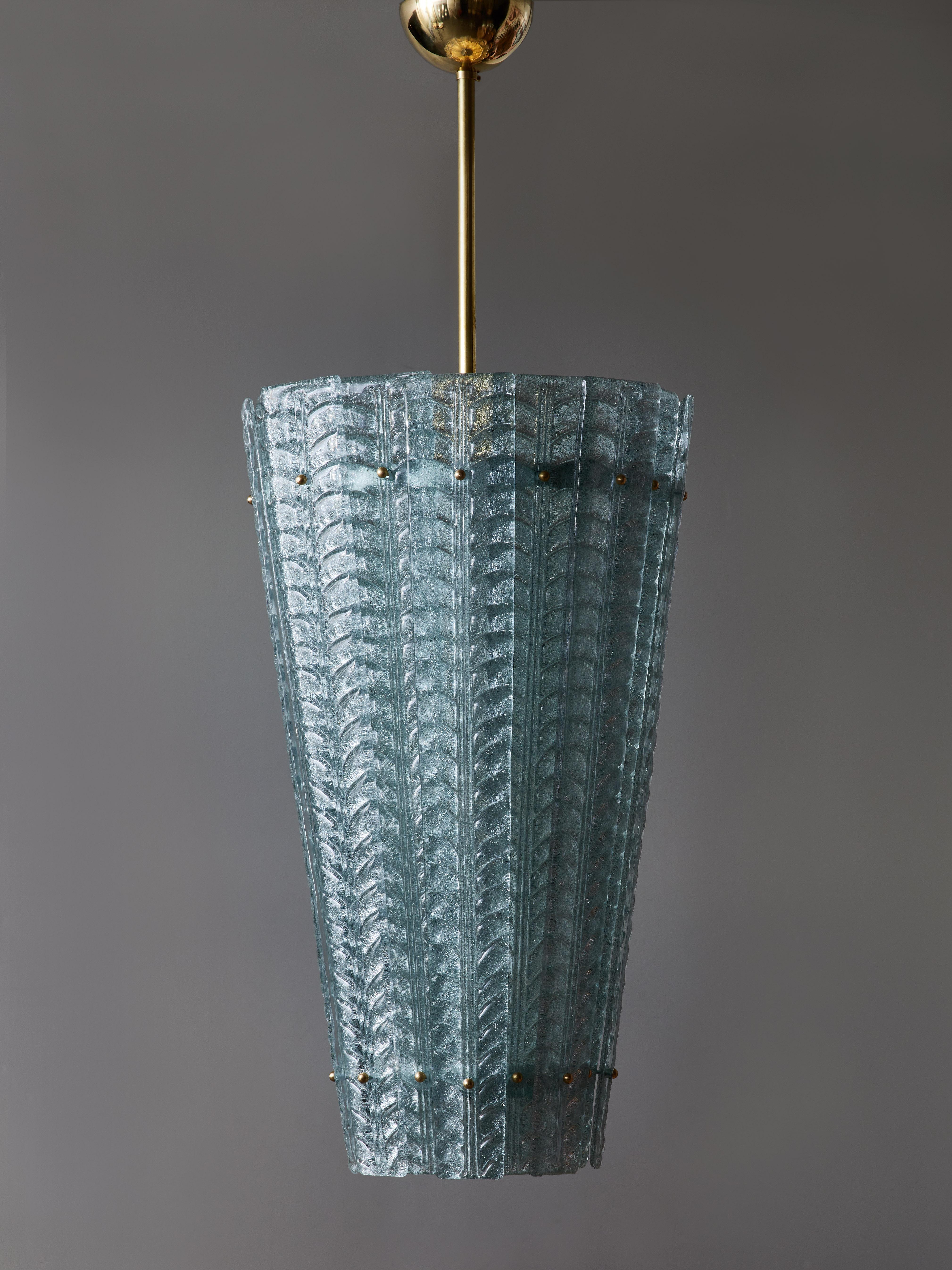 Lantern made of a brass structure and central stem covered by Murano glass slabs overlapping each other. Each glass part is embossed with leaves motifs and the whole slab is made of clear teal blue.