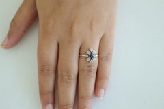 Clear Blue Sapphire Surrounded by Round Brilliant Cut Diamond Ring in 18k Gold