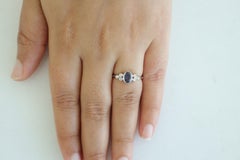 Zaffiro blu chiaro circondato da diamanti rotondi taglio brillante in oro 18 carati